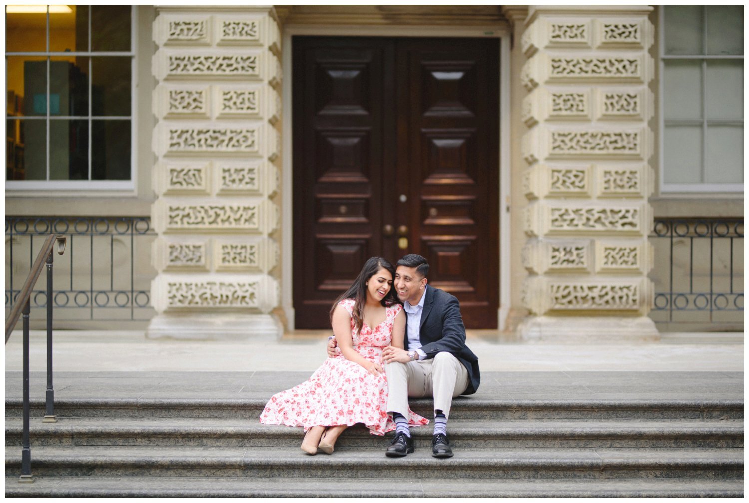 couple sitting on the steps at Osgoode Hall for their engagement photography