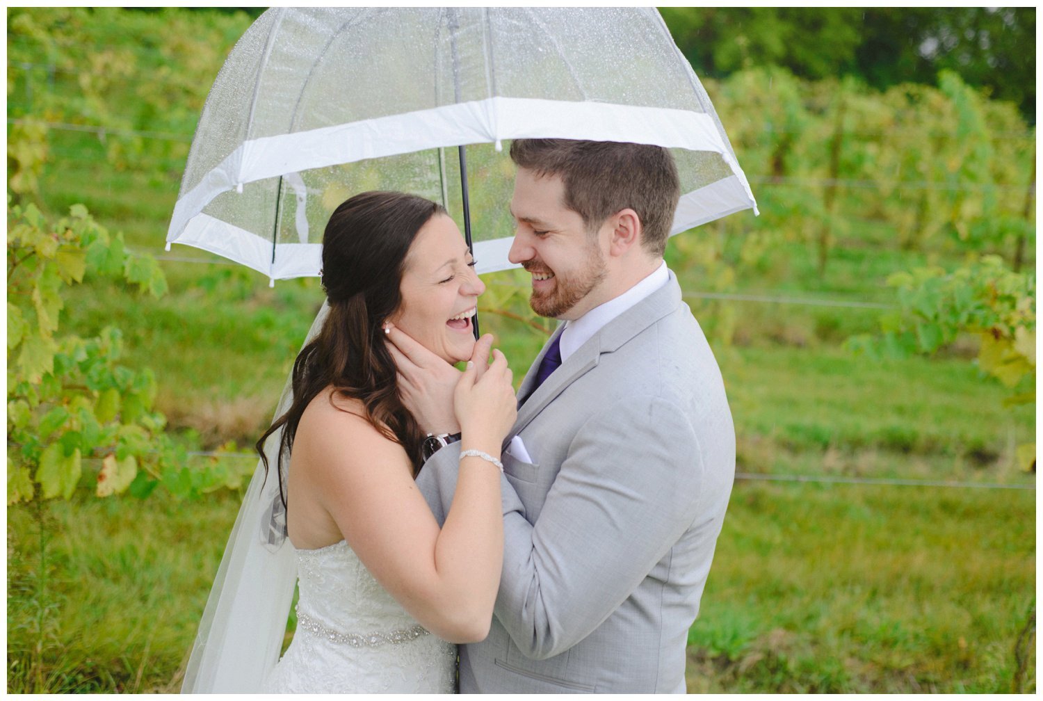 bride and groom laughing in the rain at Holland Marsh Winery Wedding in Newmarket