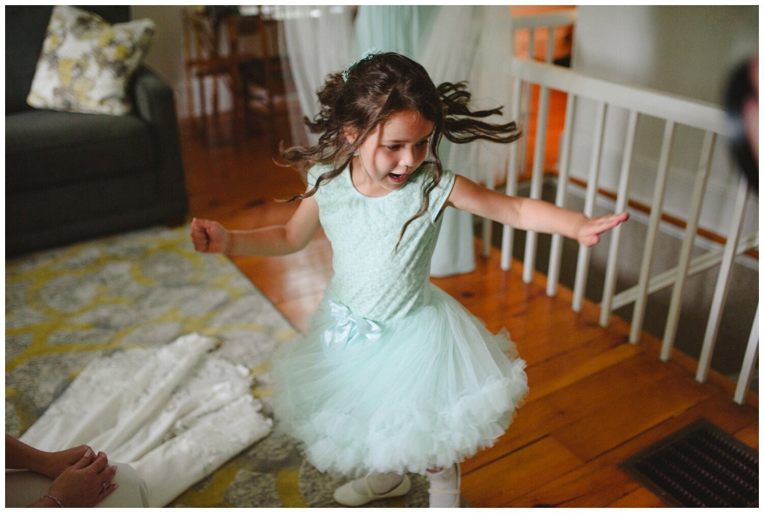 flower girl dancing while getting ready at backyard tent wedding in Claremont Ontario