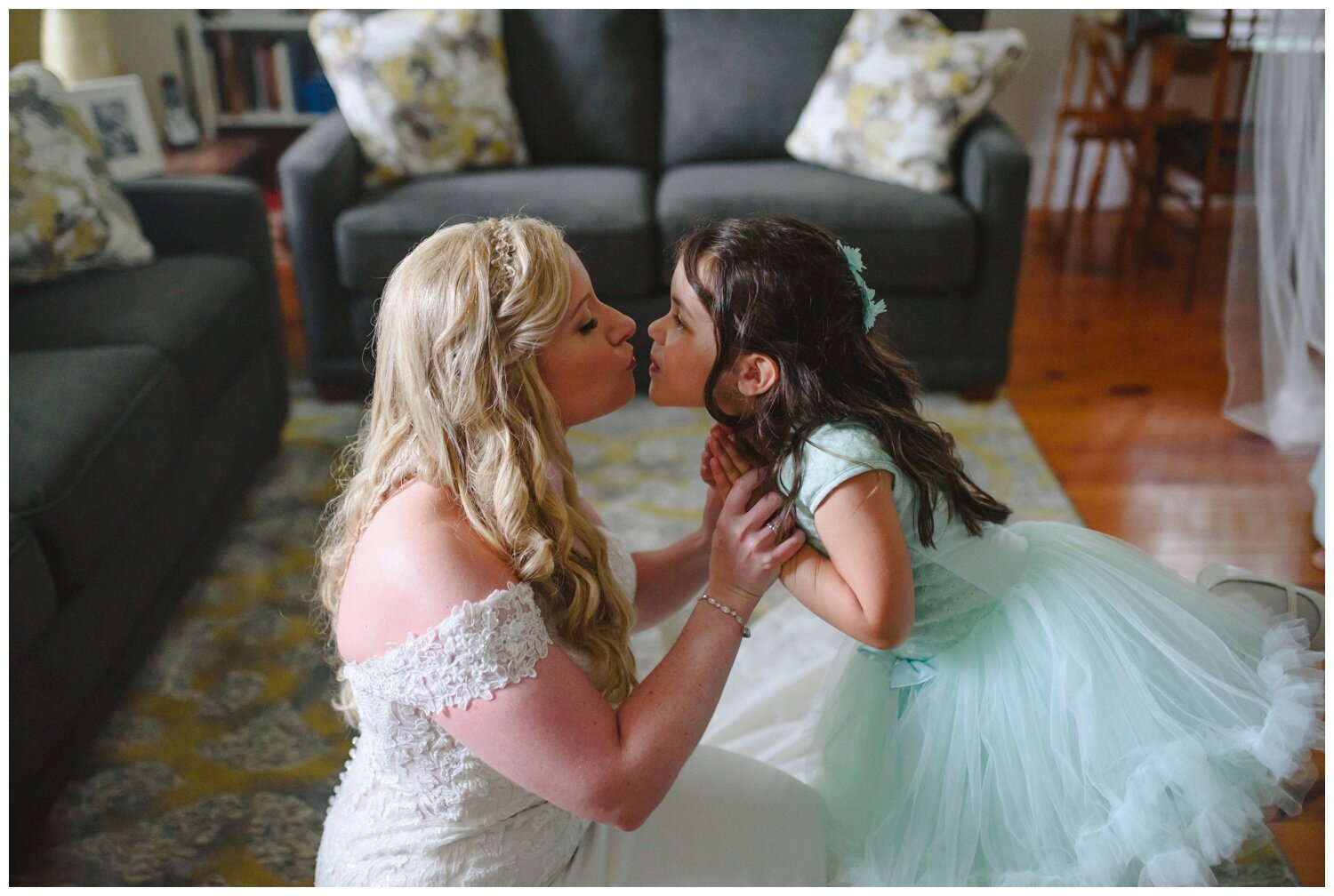 bride kissing her flower girl at backyard tent wedding in Claremont Ontario