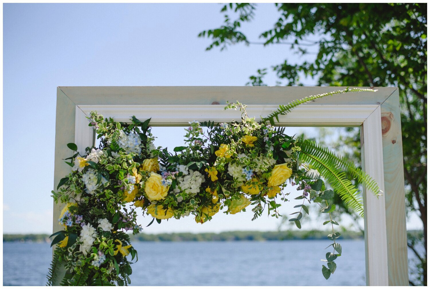 yellow floral ceremony archway at intimate wedding at Barrie Yacht Club