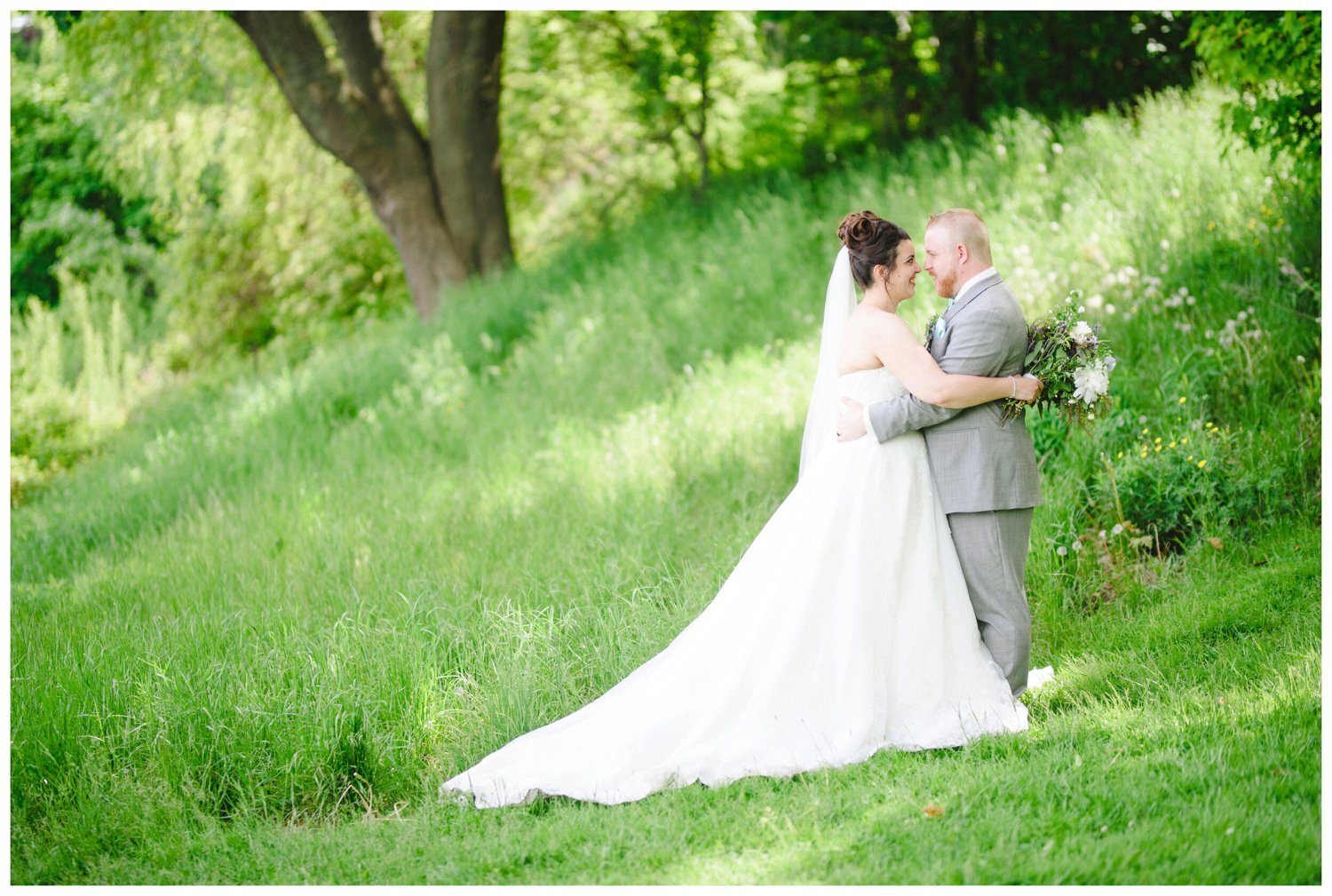 bride and groom kissing in the park at Lakeside Park in Oshawa