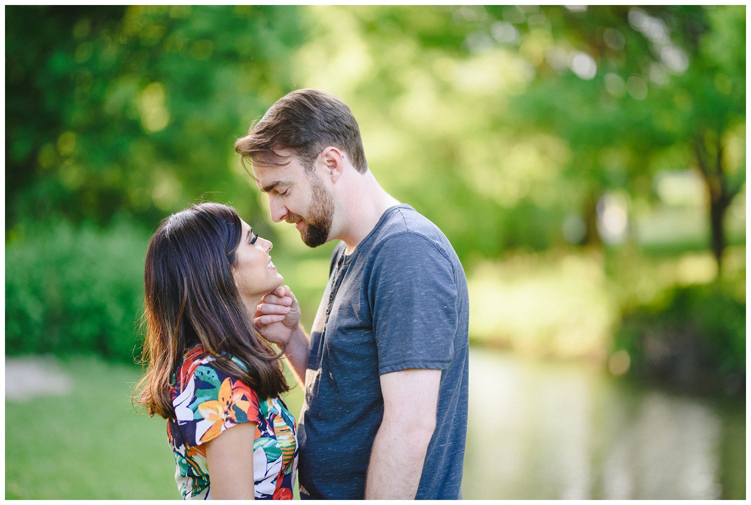 couple by the river at Oshawa Botanical Gardens Engagement Shoot