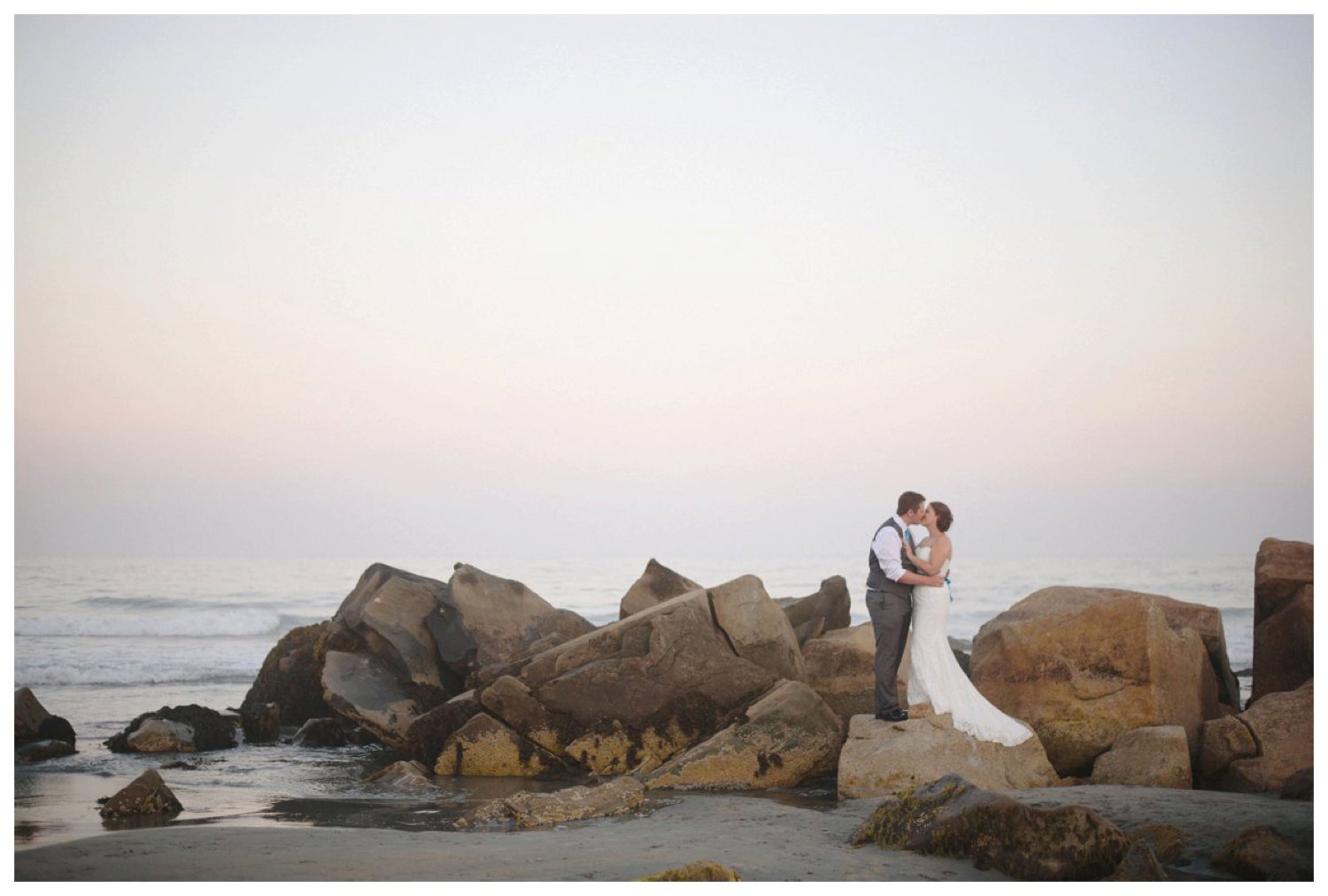couple on the rocks at Whitepoint Beach Resort Nova Scotia Wedding