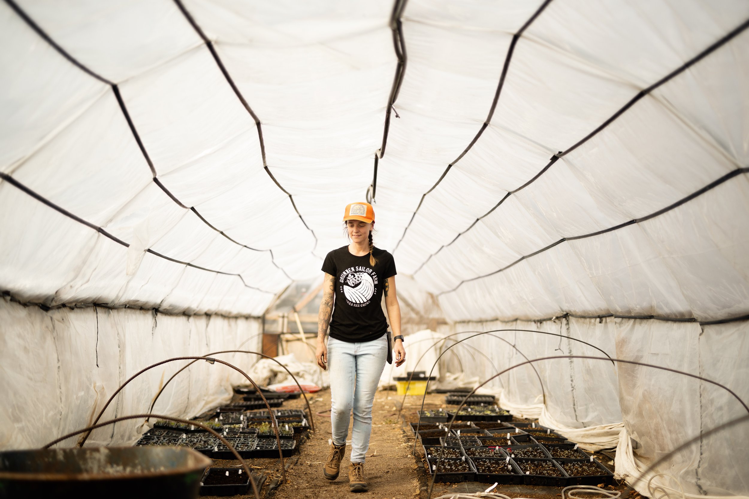  Drunken Sailor Farm owner Kendra Damnjanovic walks through a greenhouse at her farm in Boise. 