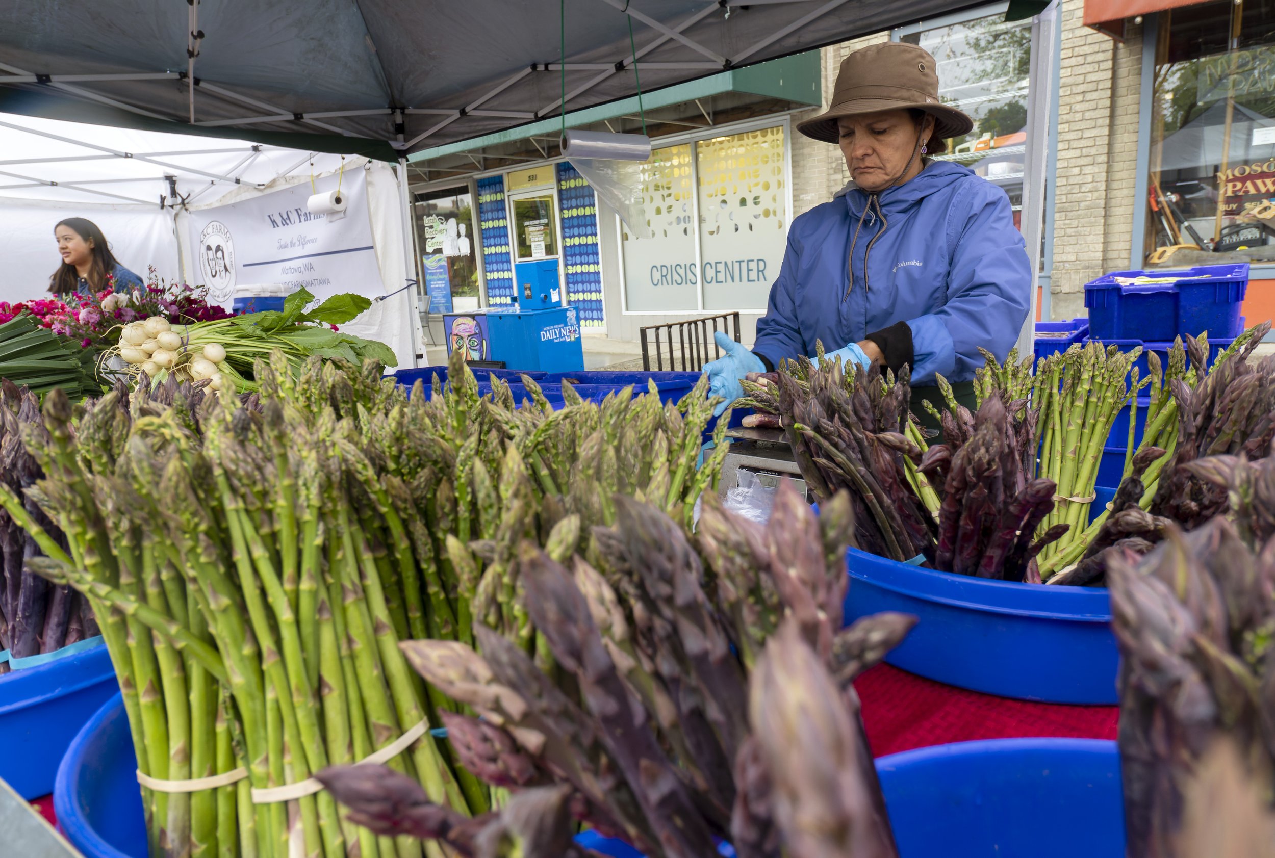 A woman sells asparagus at the Moscow Farmers Market