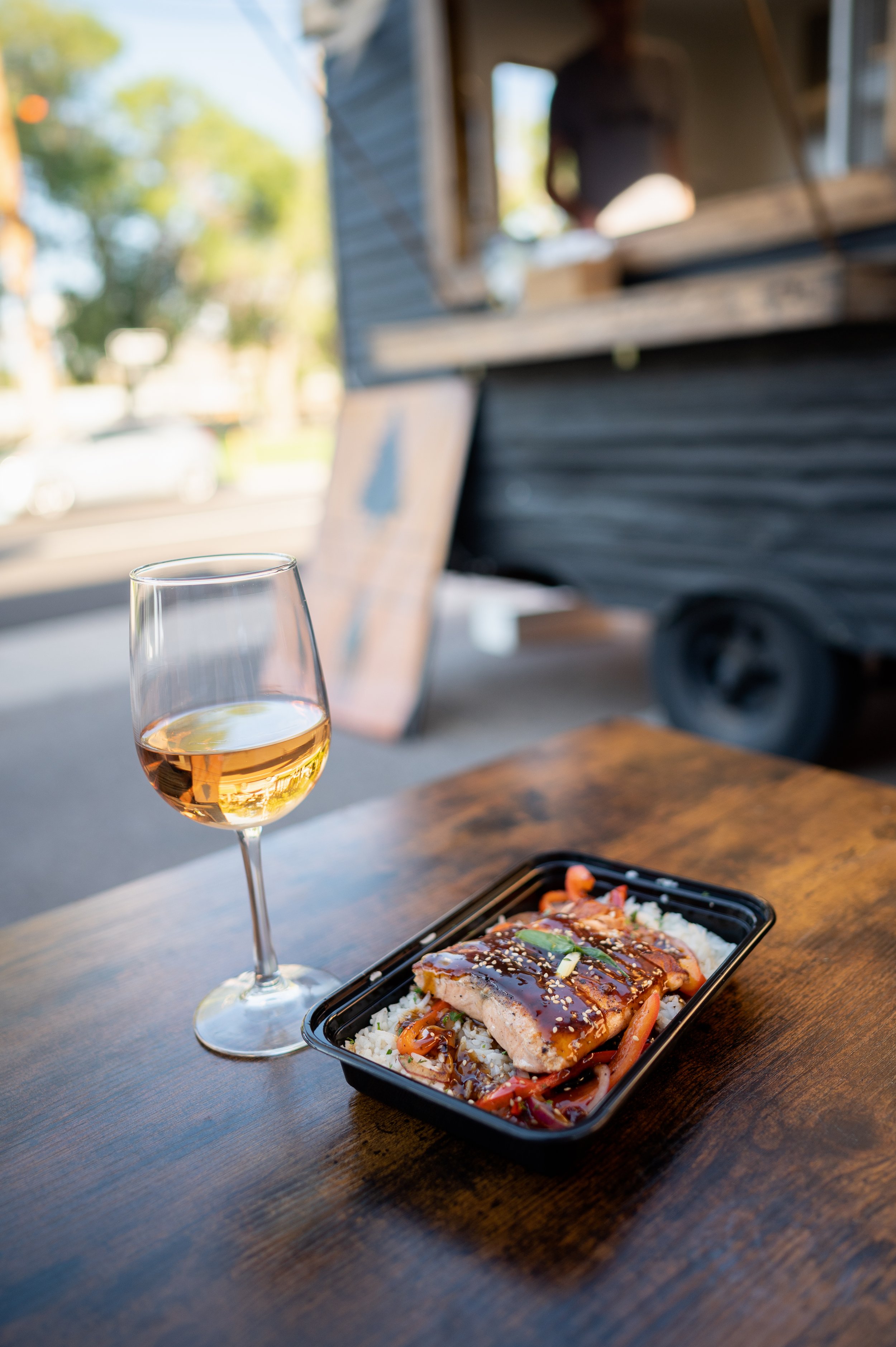 The teriyaki salmon bowl from Thrive with a glass of rose from Brick 243.
