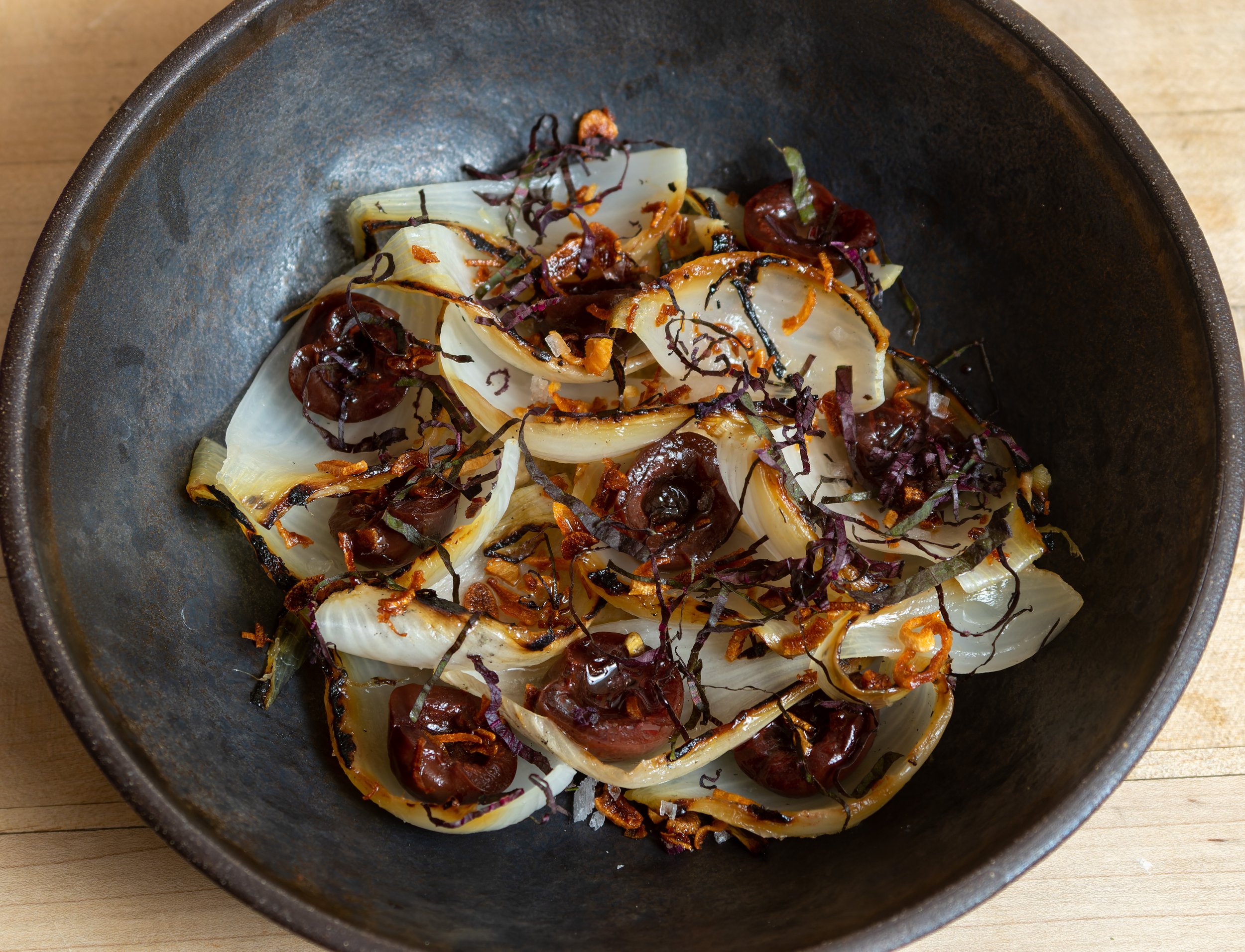 The final dish: Char-grilled Pokey Creek onions with a smoky eggplant dip, cherries pickled in a vinegar made of their own kernels &amp; red Shiso.