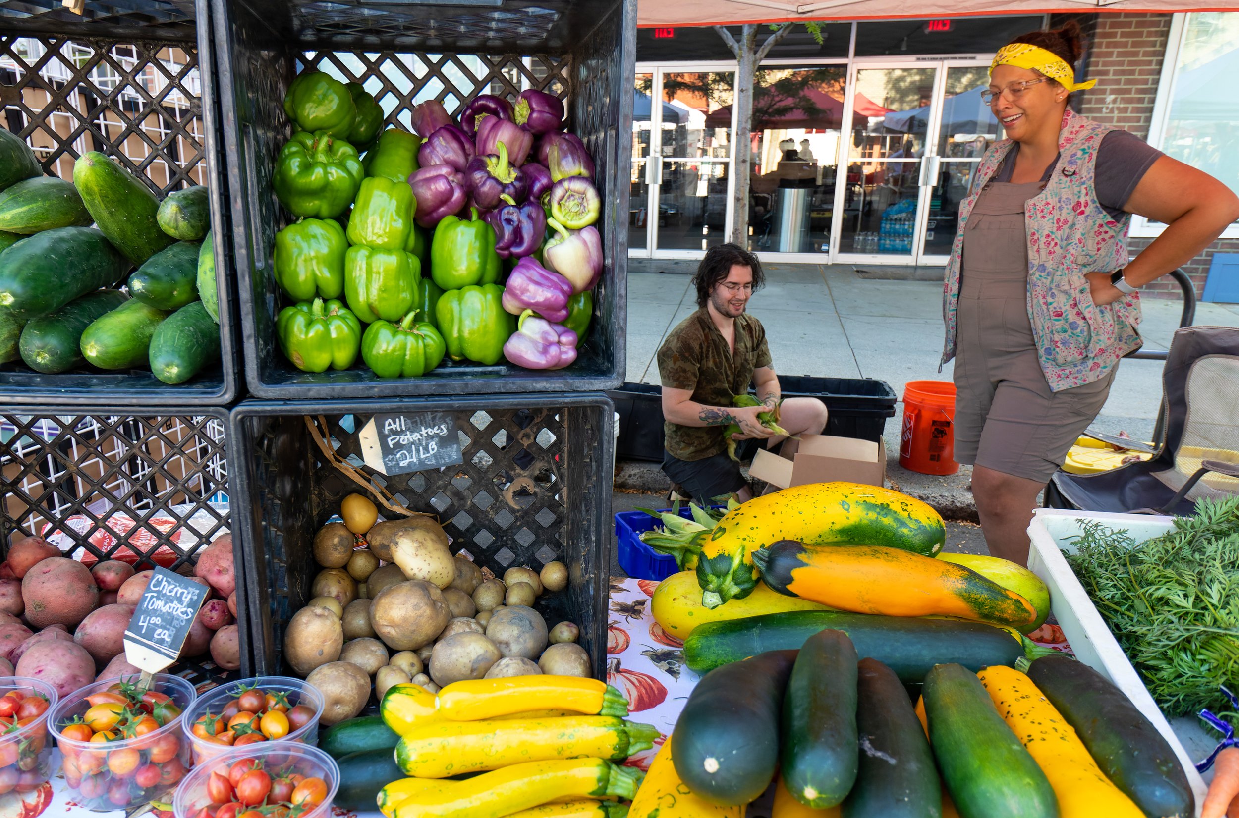 Pecoraro talks with Carrie Stewart while buying corn from Lewiston's Stewart Family Farms at the Moscow Farmers Market.