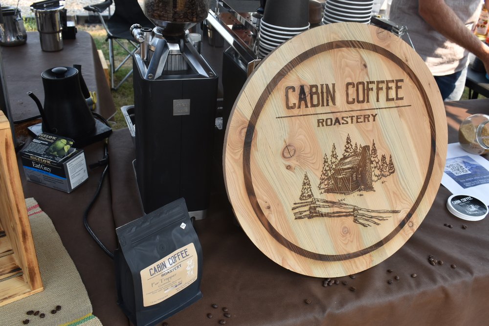 Cabin Coffee Roastery sign surrounded by roasting equipment 
