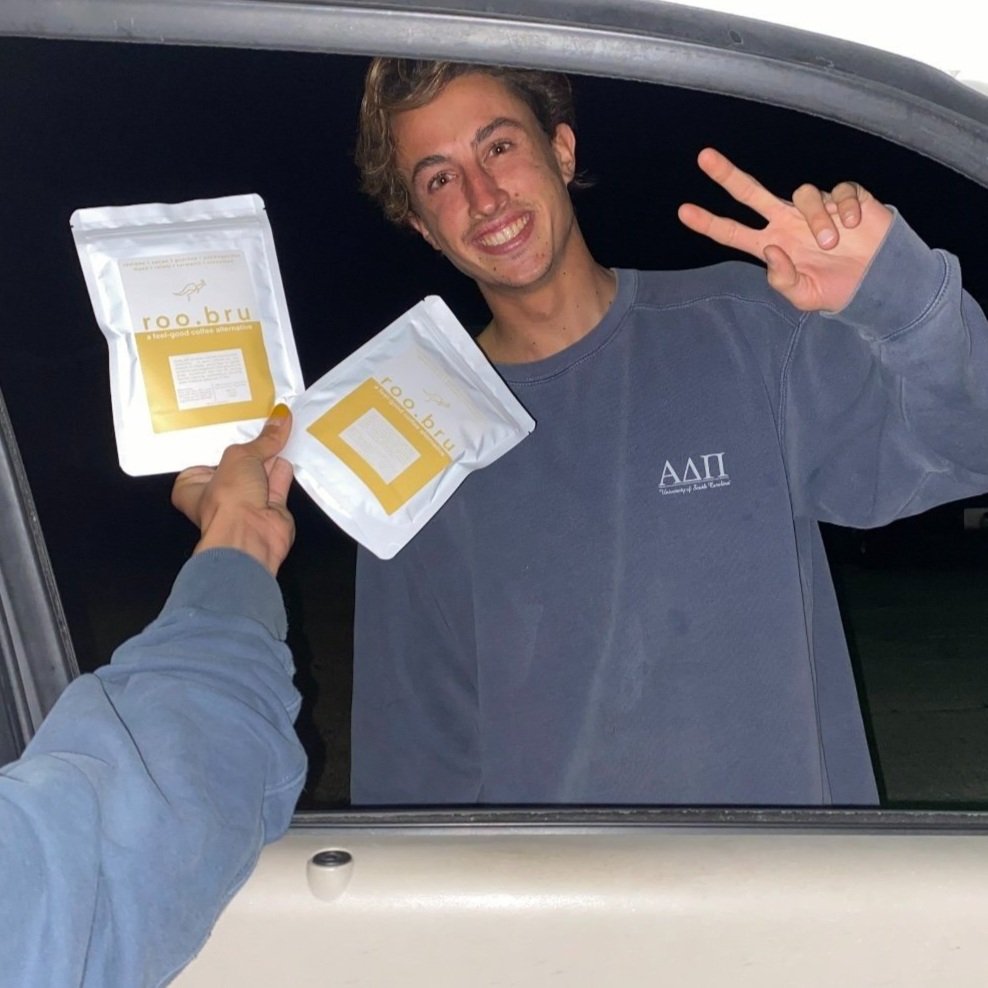 Friends picking up the first edition of roo.bru (nobody could read the packaging)