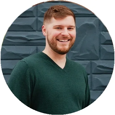 A smiling man with short hair and a beard.