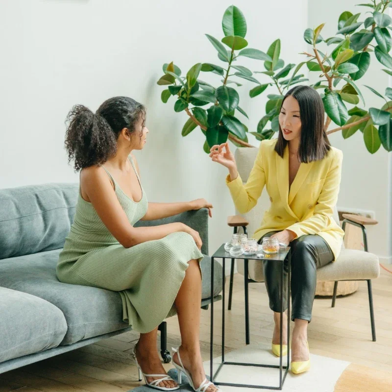 Two women having a conversation inside.