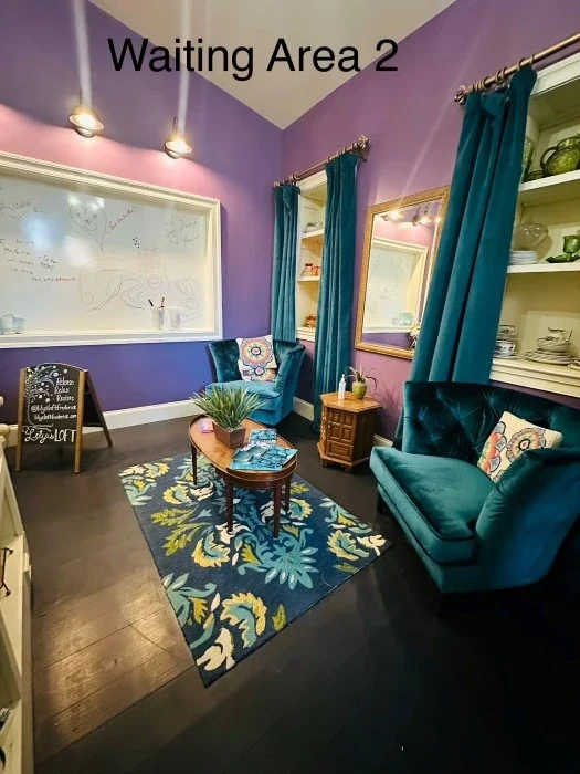 A waiting area with two blue cozy chairs.