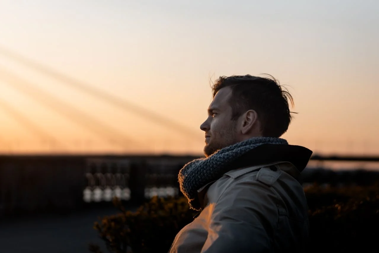 man-wearing-gray-coat-during-golden-hour