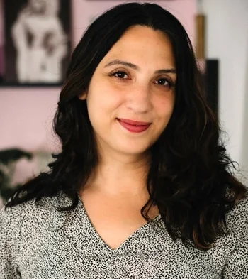 A woman with dark hair, smiling.