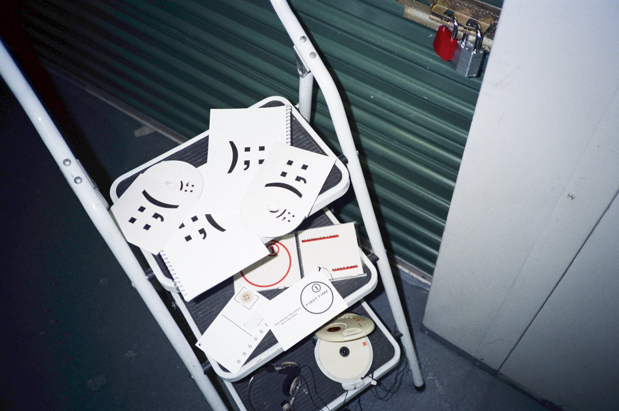 F1RST T1ME ZINE 1 & ZINE 2 from the :;( );: mixtape, displayed with physical audio CDs and printed materials, featuring white covers with abstract black symbols.