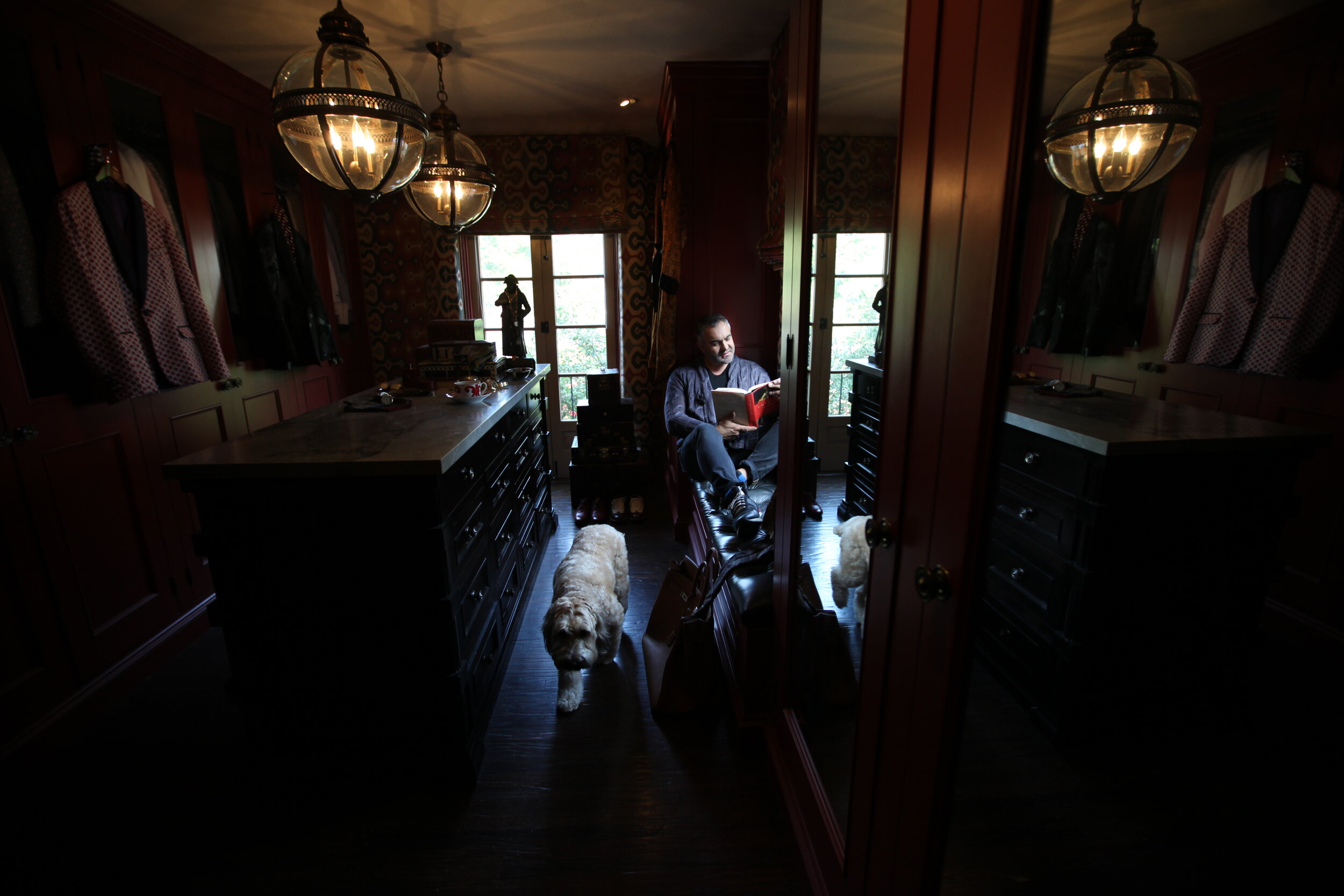  Interior designer Martyn Bullard relaxes in his closet/sitting room in Hollywood with his dog.  