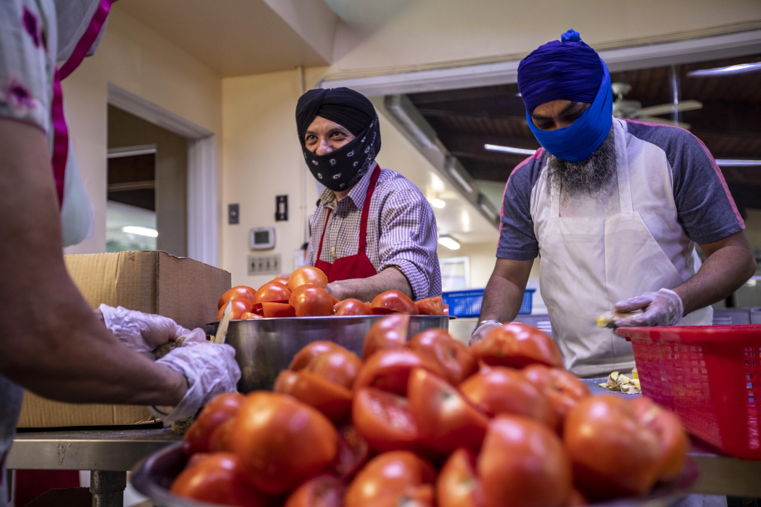  Ranbhir Singh and Varinder Singh prepare food at Khalsa Care Foundation. The Sikh community is working with the Mayor's office and Department of Disability and serving 3,000 meals daily. They have 50-55 volunteers that show up Monday through Friday 