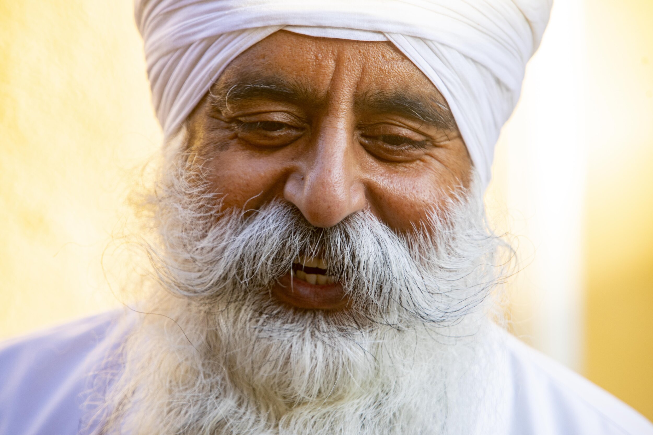  Manjeet Singh smiles as he gets ready to put his mask back on after taking a break to eat. He is the head chef and has been preparing food at Khalsa Care Foundation. The Sikh community in Pacoima is working with the mayor's office and Department on 