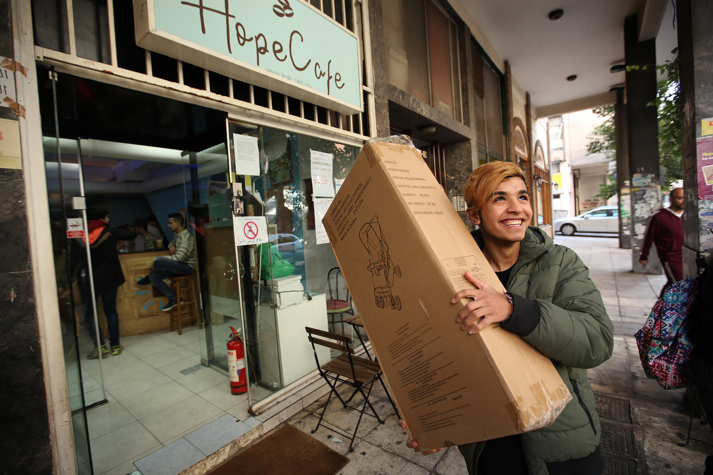  Volunteer and refugee Rami unloads one of the 7 new strollers donated by Allied Aid to Hope Cafe for refugees in Athens, Greece. 