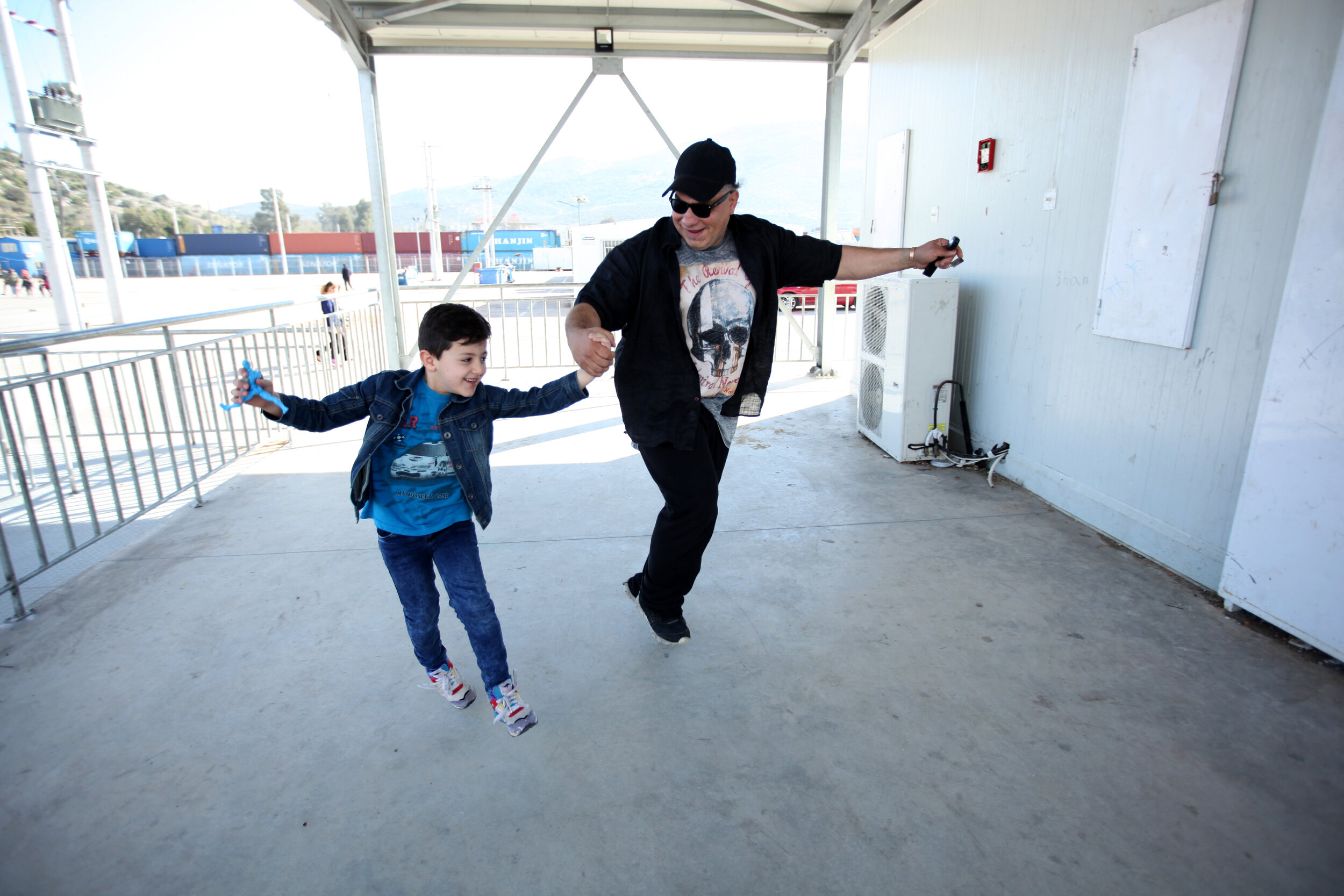  Allied Aid volunteer Fadi Sayde dances with a boy who lives at the Skaramagas refugee camp in Athens, Greece.  