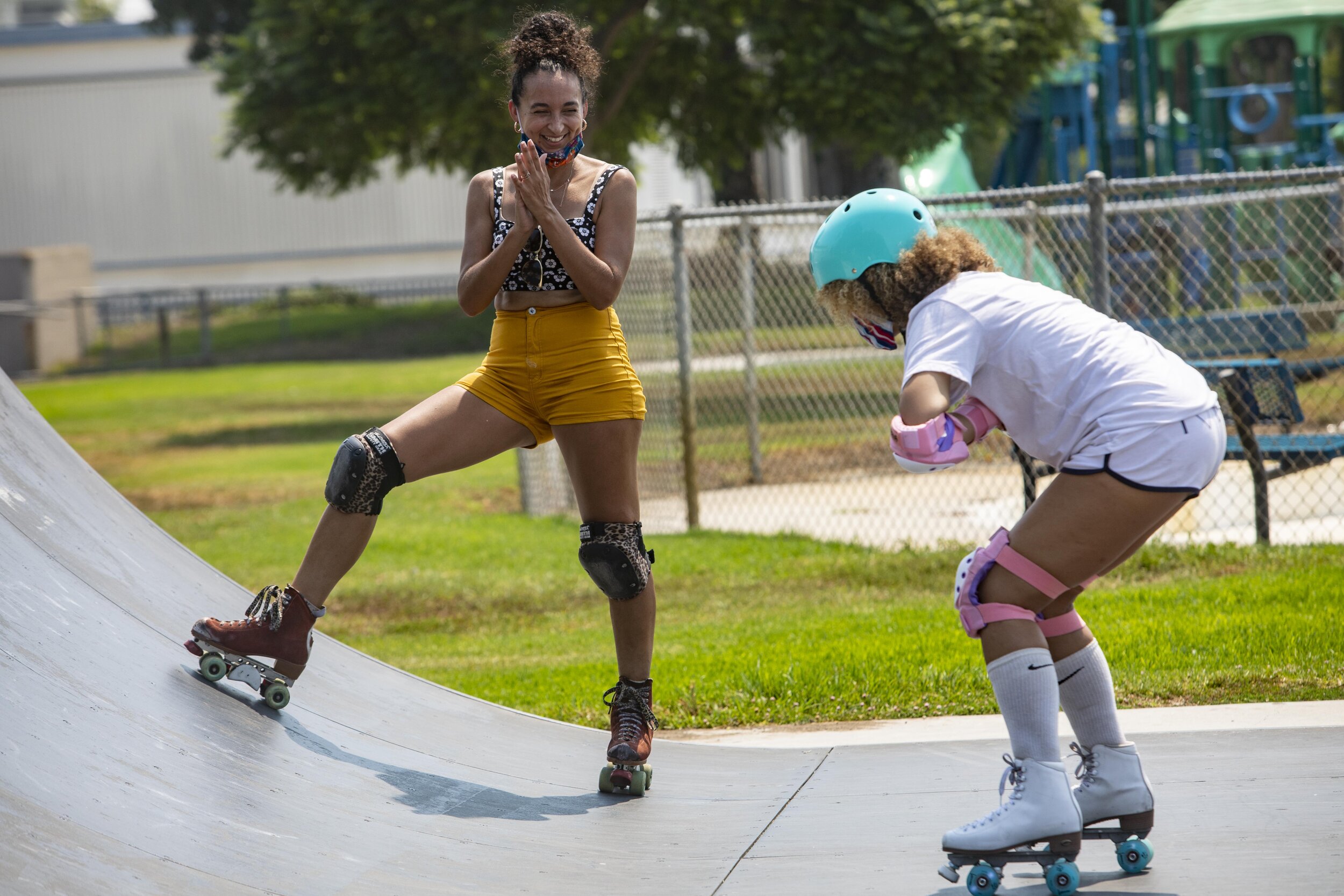   Frances McGee ( known by her skate name of Abominatrix) teaches actress/poet Yazmin Monet Watkins how to use the ramp at the "You Good Sis" event at Rogers Park in Inglewood, Calif.  as part of the Rise &amp; Skate day of activism on Aug. 22. You G