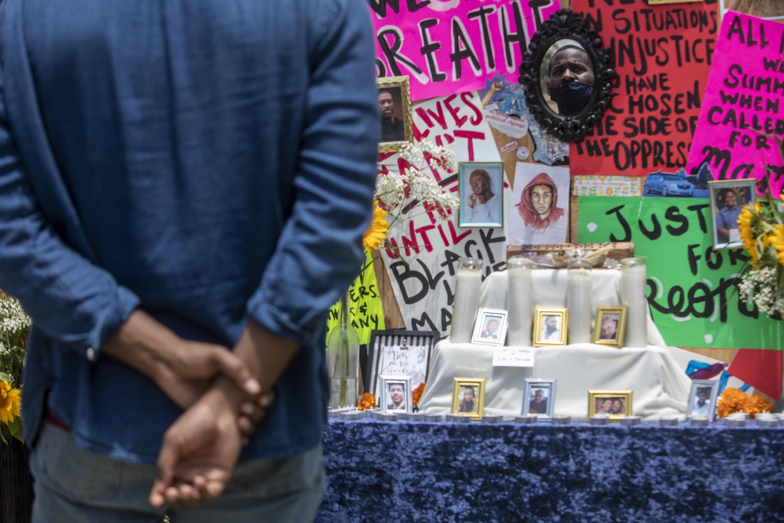  David Fortune looks at the "Pray for the Hood" altar at the 11th Annual Juneteenth Celebration at Leimert Park in Los Angeles. 