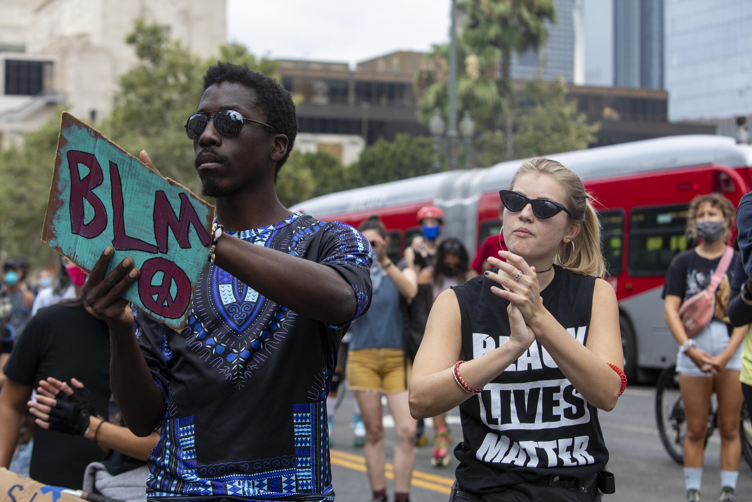  Wendell Phipes (left)and Tricia Plinzke clap as they listen to a speaker in front of City Hall at the Rise &amp; Skate all wheels welcome protest in celebration of Juneteenth and in solidarity with Black Lives Matter in Los Angeles.  