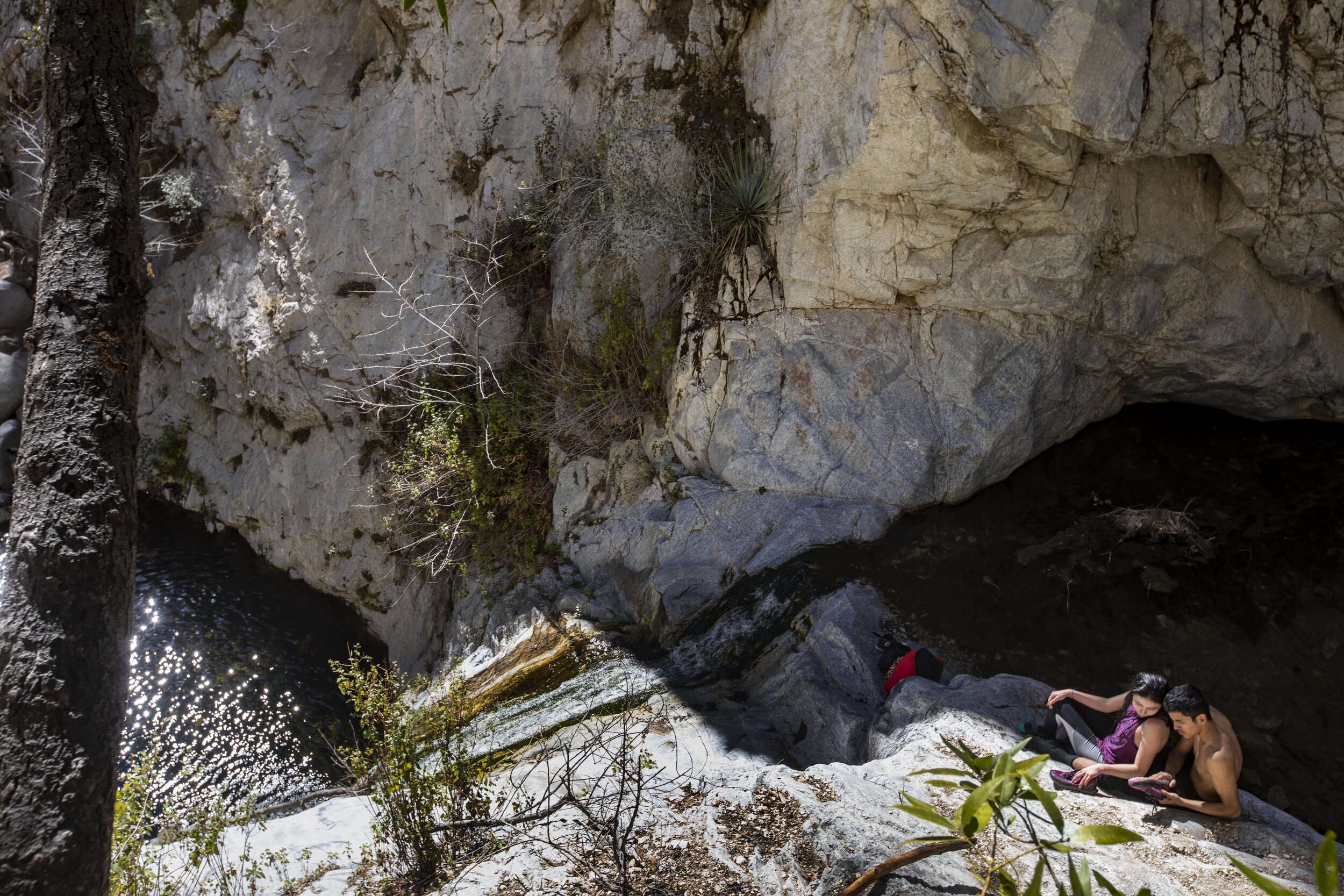  Manuel Ceniceros and Yanette Oseguera take a break from their swim in the pool above the lower falls at Switzer Falls, a popular waterfall hike in the San Gabriel Mountains in Los Angeles County. 
