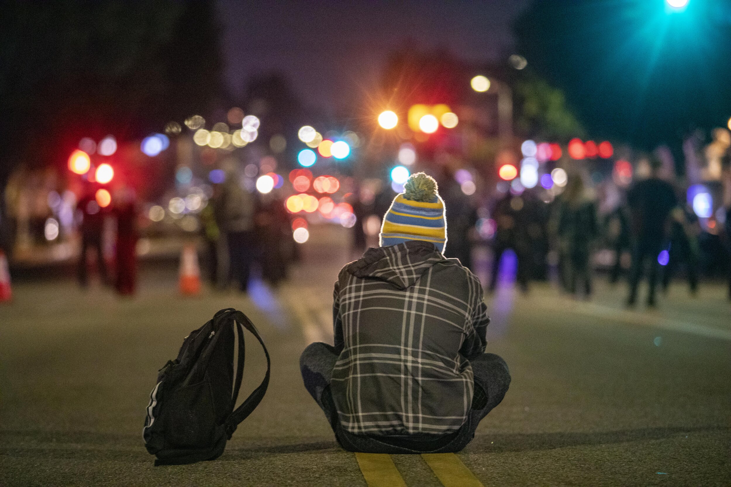  A protester sits in the middle of  Sunset Boulevard in Echo Park where advocates in support of the homeless protest against the removal of their encampments from the Echo Park Lake area, which has been fenced off. LAPD later declared an unlawful ass