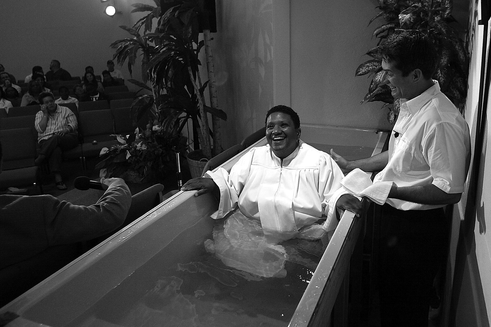   Kathy Payton smiles during her baptism at Christ Chapel, a predominantly gay Christian Church in North Hollywood, Calif.  According to the church’s pastor Jerrell Walls, at right,  “The immersion in water comes from the Greek word for baptism meani