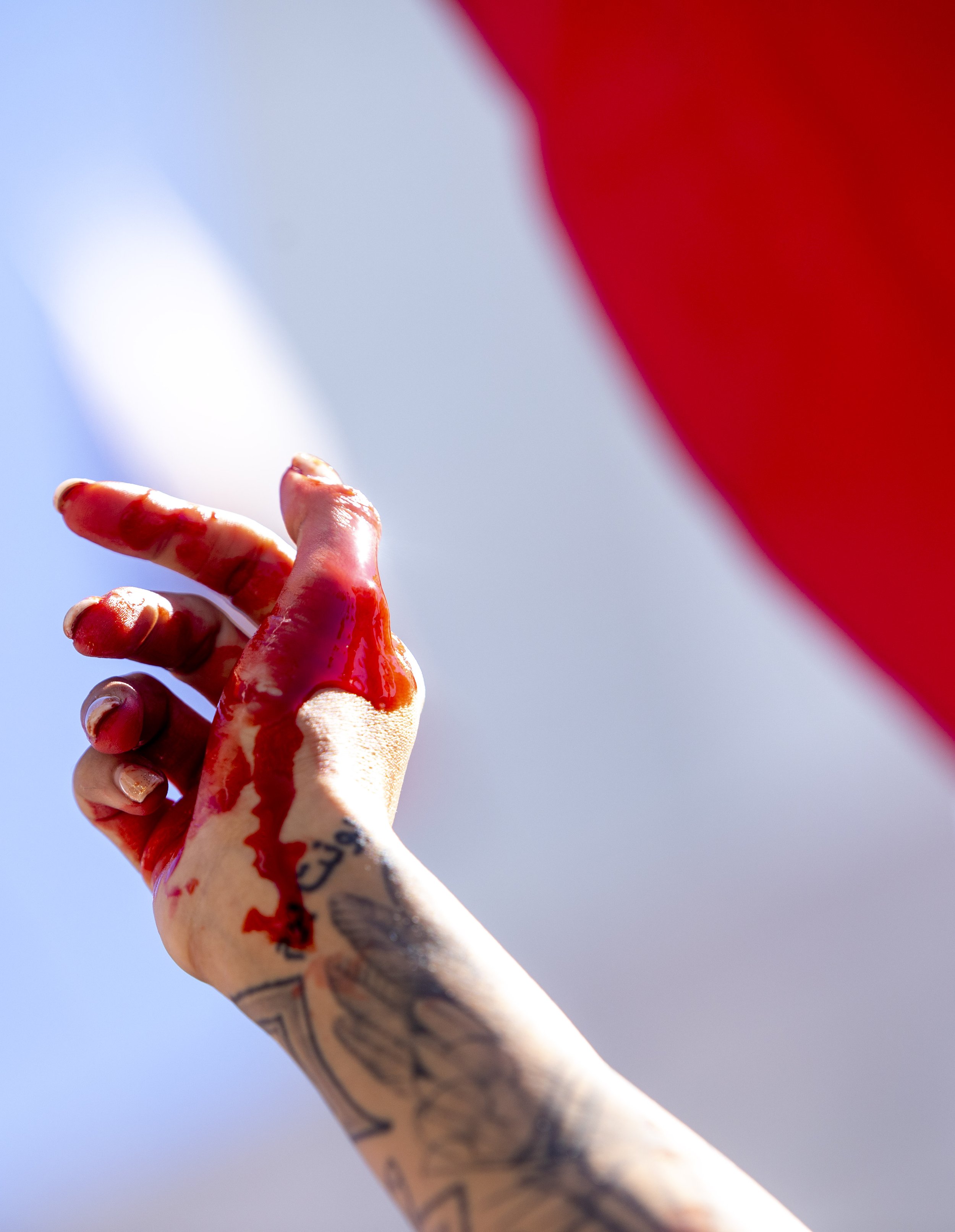  Artist Samantha Rose Moshiri  (left) and Yadriga Krasovskaya, covered in fake blood in a performance in solidarity with Maha Amini outside City Hall  at a Freedom Rally for Iran in  Downtown Los Angeles, which is part of a global protest in over 120