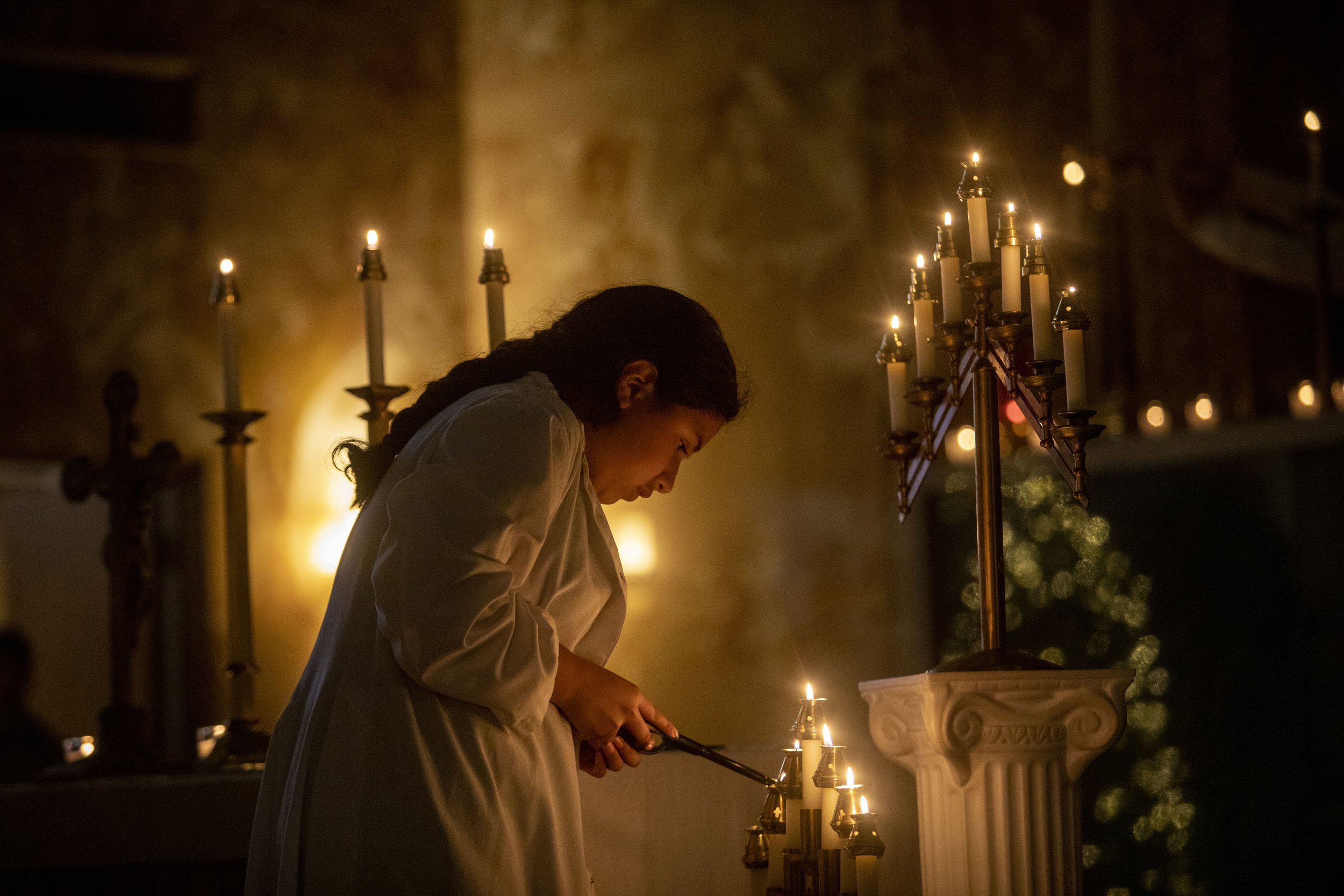  Elissa Esteban-Flores lights a candle before the start of the Rorate Caeli Mass, a “forgotten Advent tradition” that honors the Virgin Mary, at Our Lady of Grace Catholic Church in Encino, Calif. These masses, usually celebrated a few days before Ch