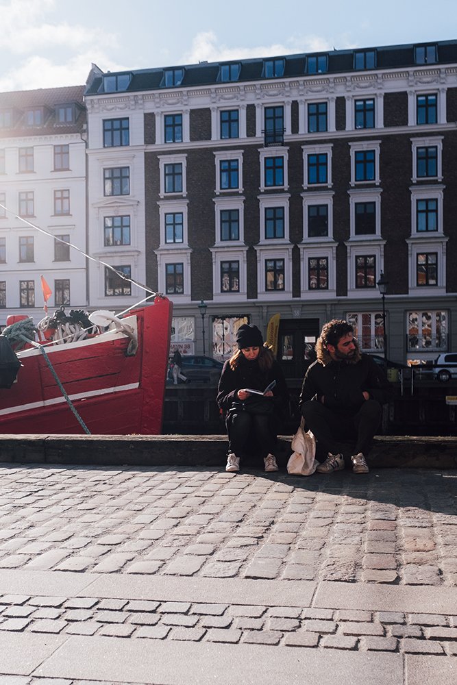 People sitting in Copenhagen tourist spot.