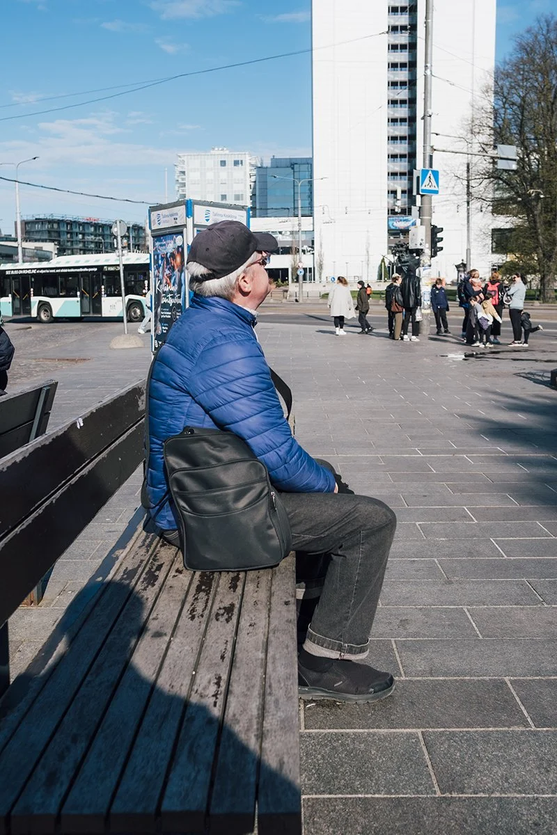 Man sitting next to Hotel Viru