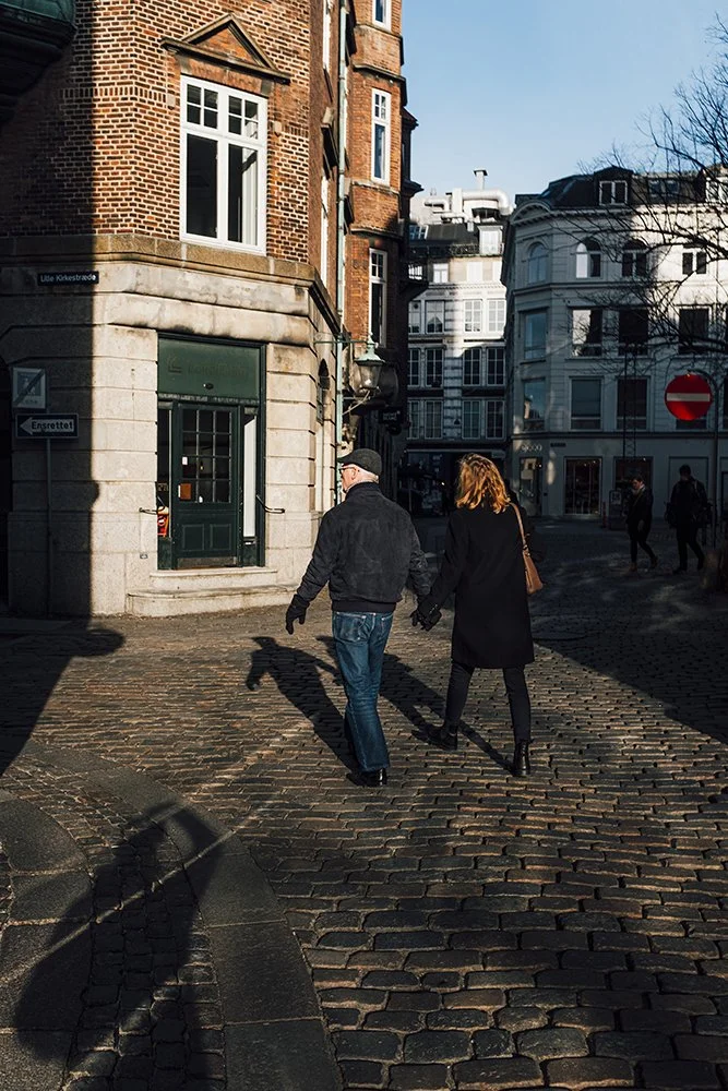 Couple walking in morning sun in Denmark Copenhagen