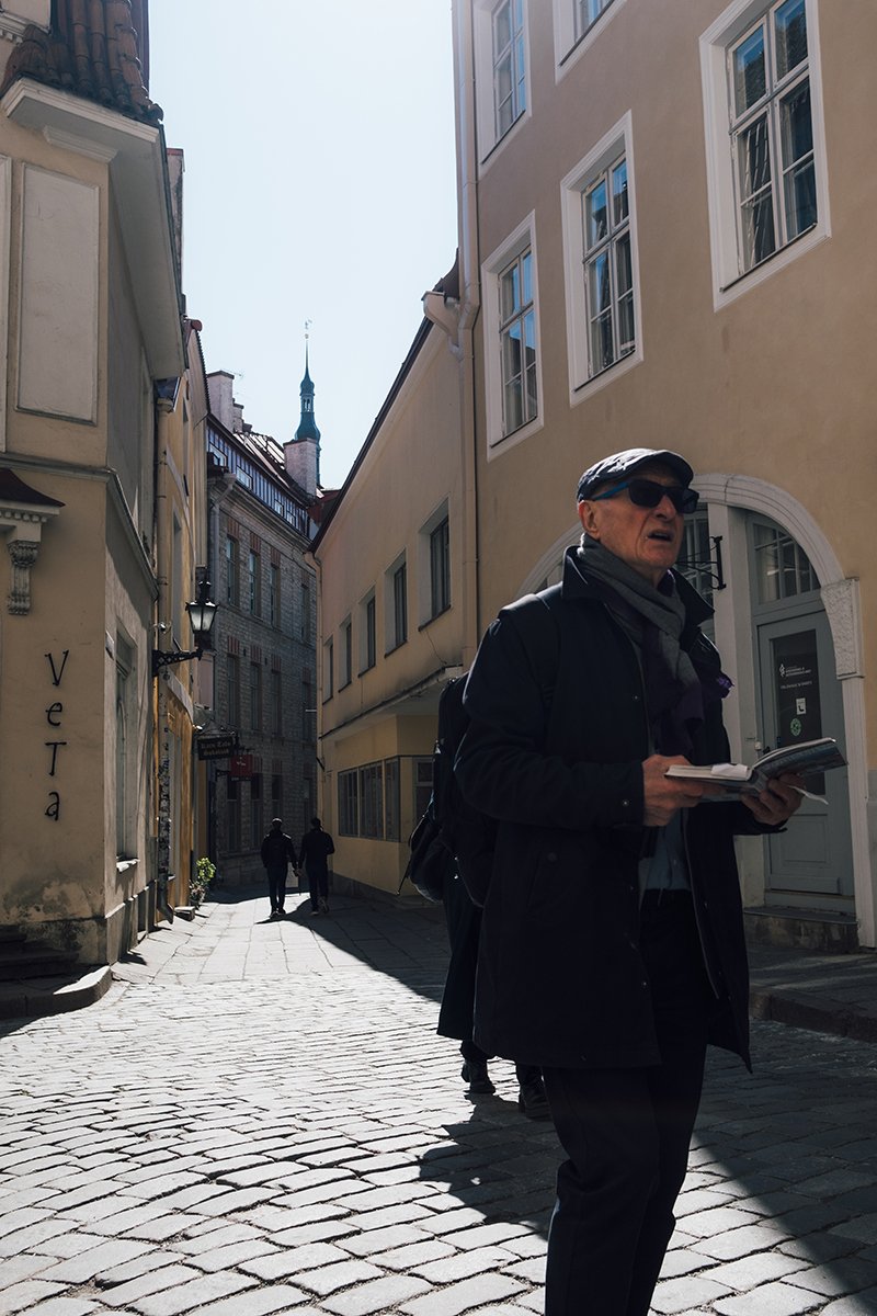 Tourist looking map in old town in Tallinn Estonia