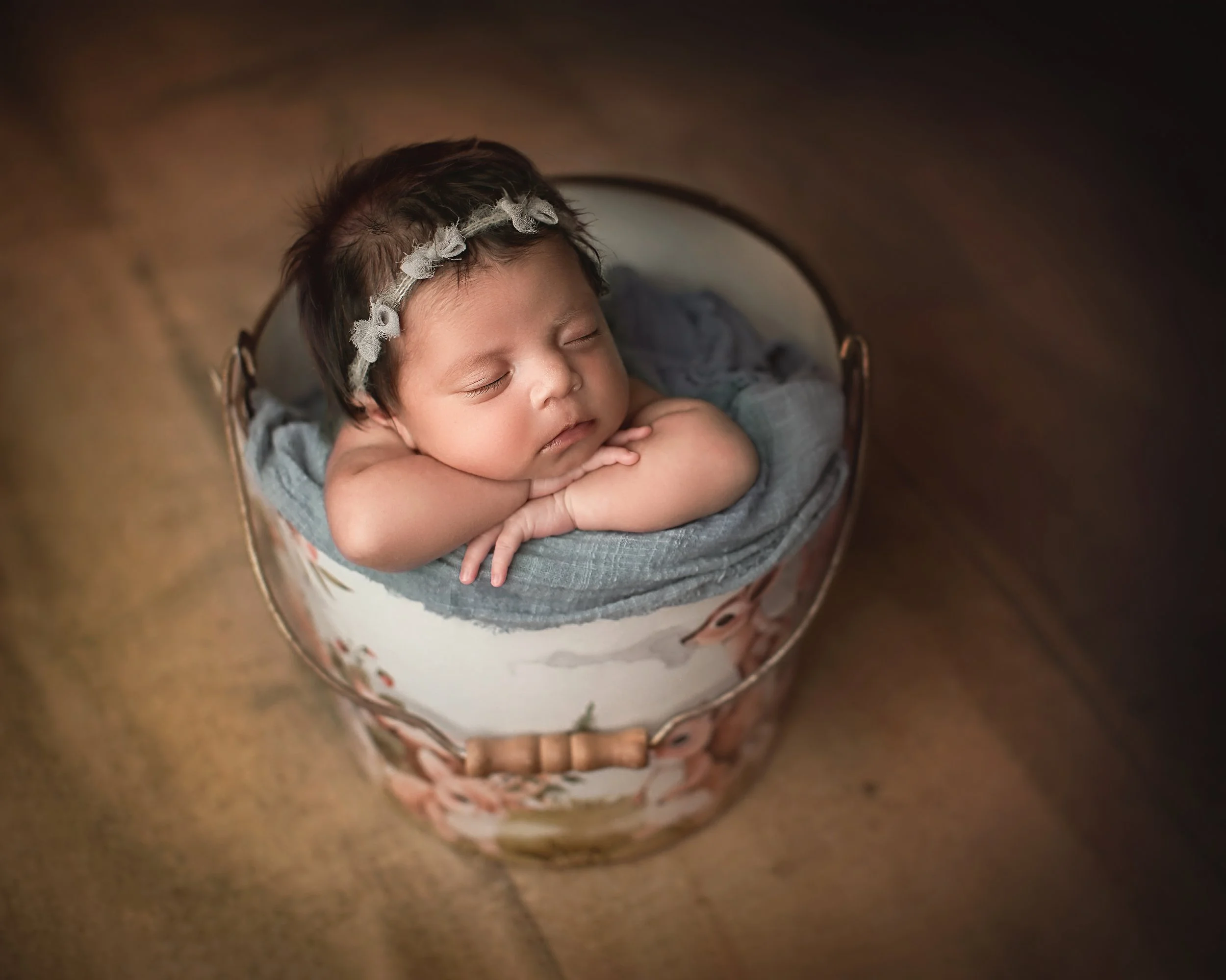 Bay Area newborn photographer located in Vacaville and Fairfield takes cute baby photos of a baby girl in a bucket