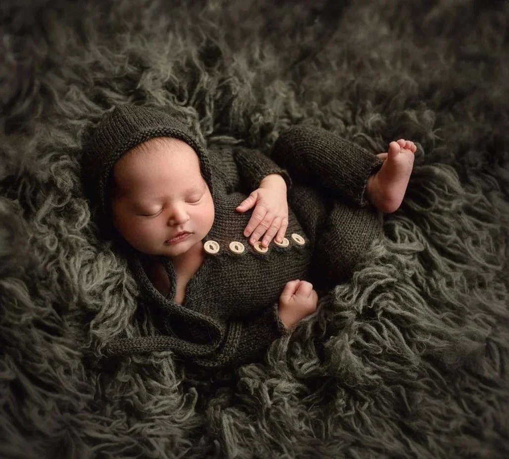 Fairfield and Vacaville newborn photographer in Northern California takes photo of a cute baby newborn boy in green