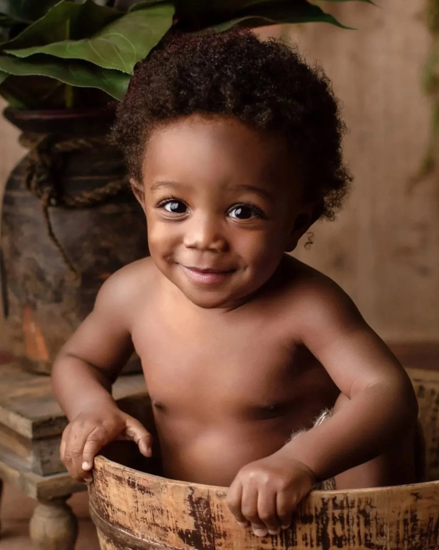 adorable baby boy in a bucket takes milestone photos in the Bay Area with a photographer