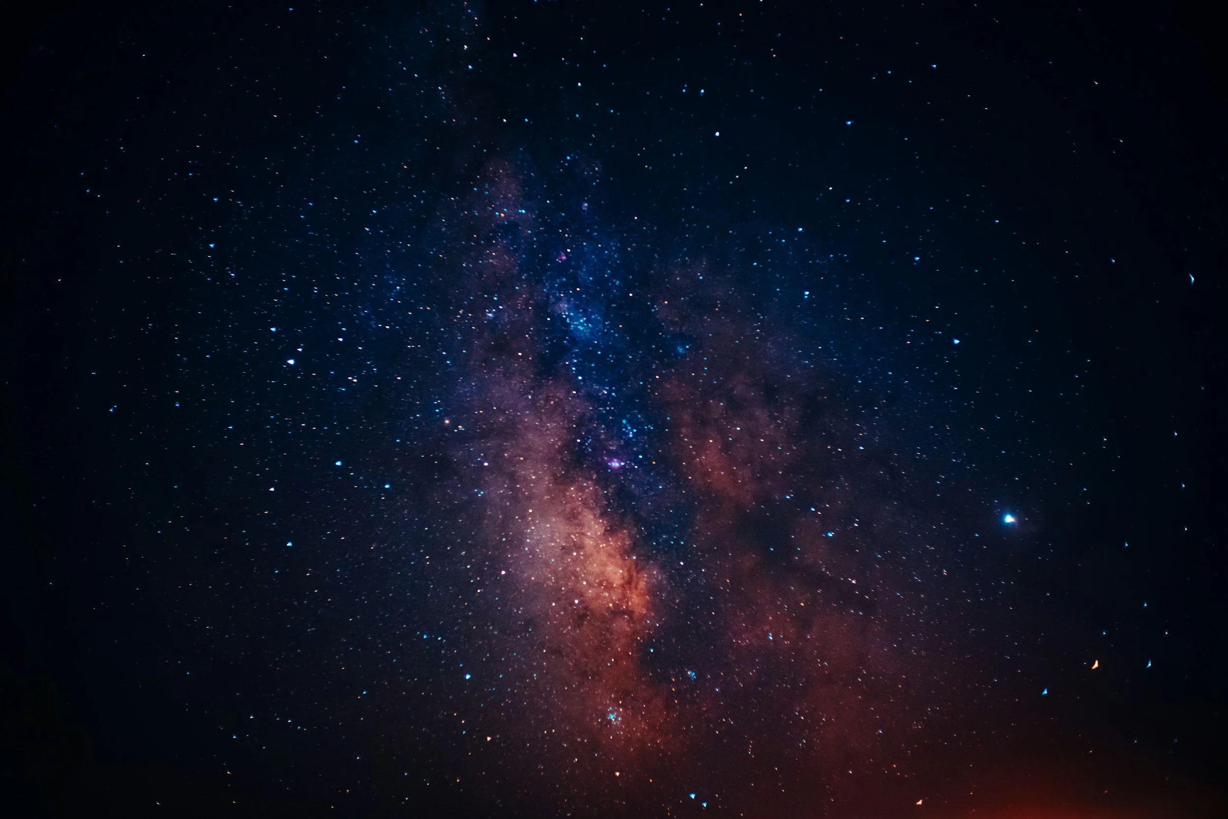 A clear night sky with a view of the Milky Way galaxy and scattered stars.