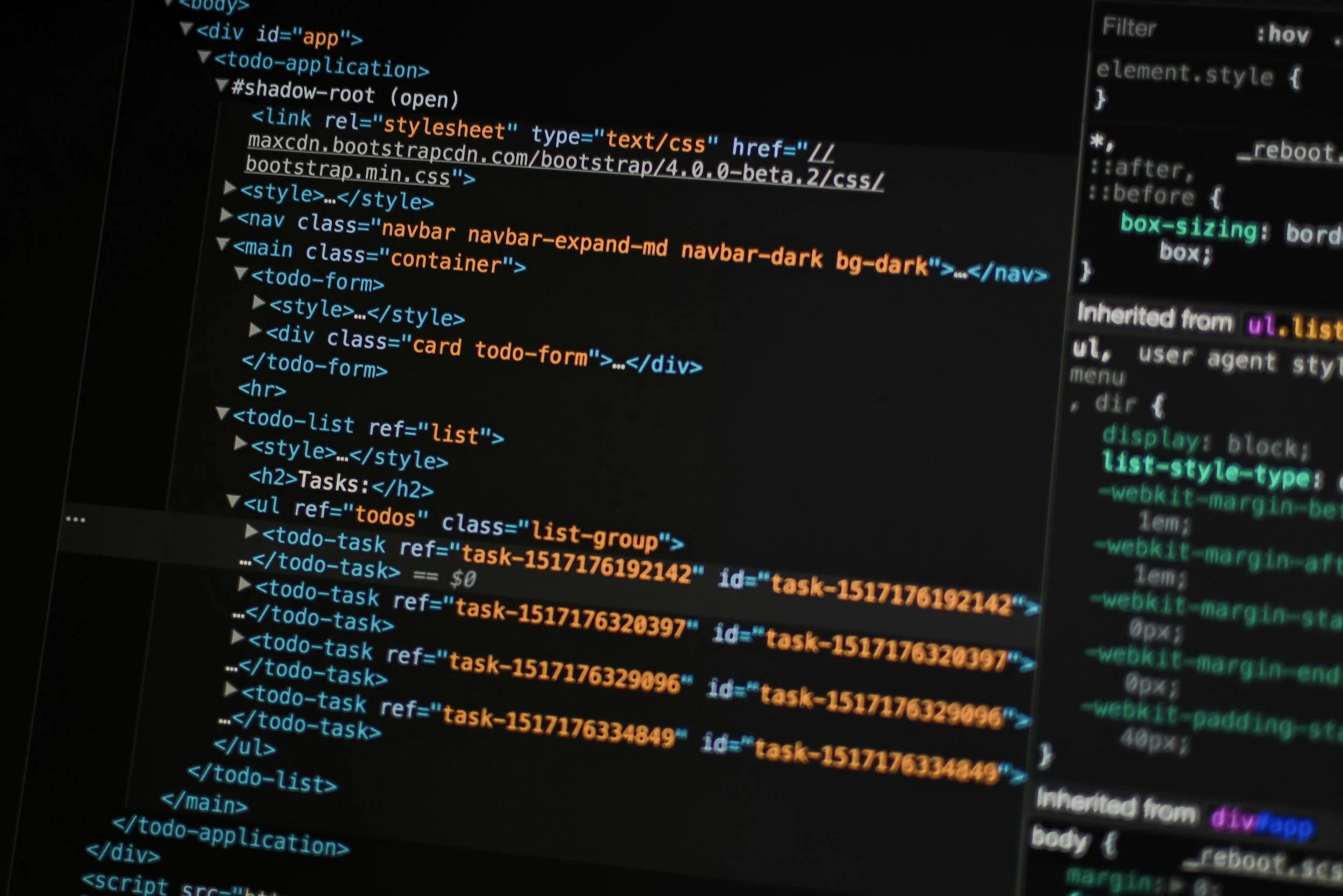 Close-up of a computer screen displaying code in a code editor with syntax highlighting, including HTML, CSS, and JavaScript elements.