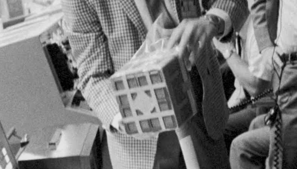 A person is performing an ultrasound procedure on a patient using a portable ultrasound device in a medical setting.