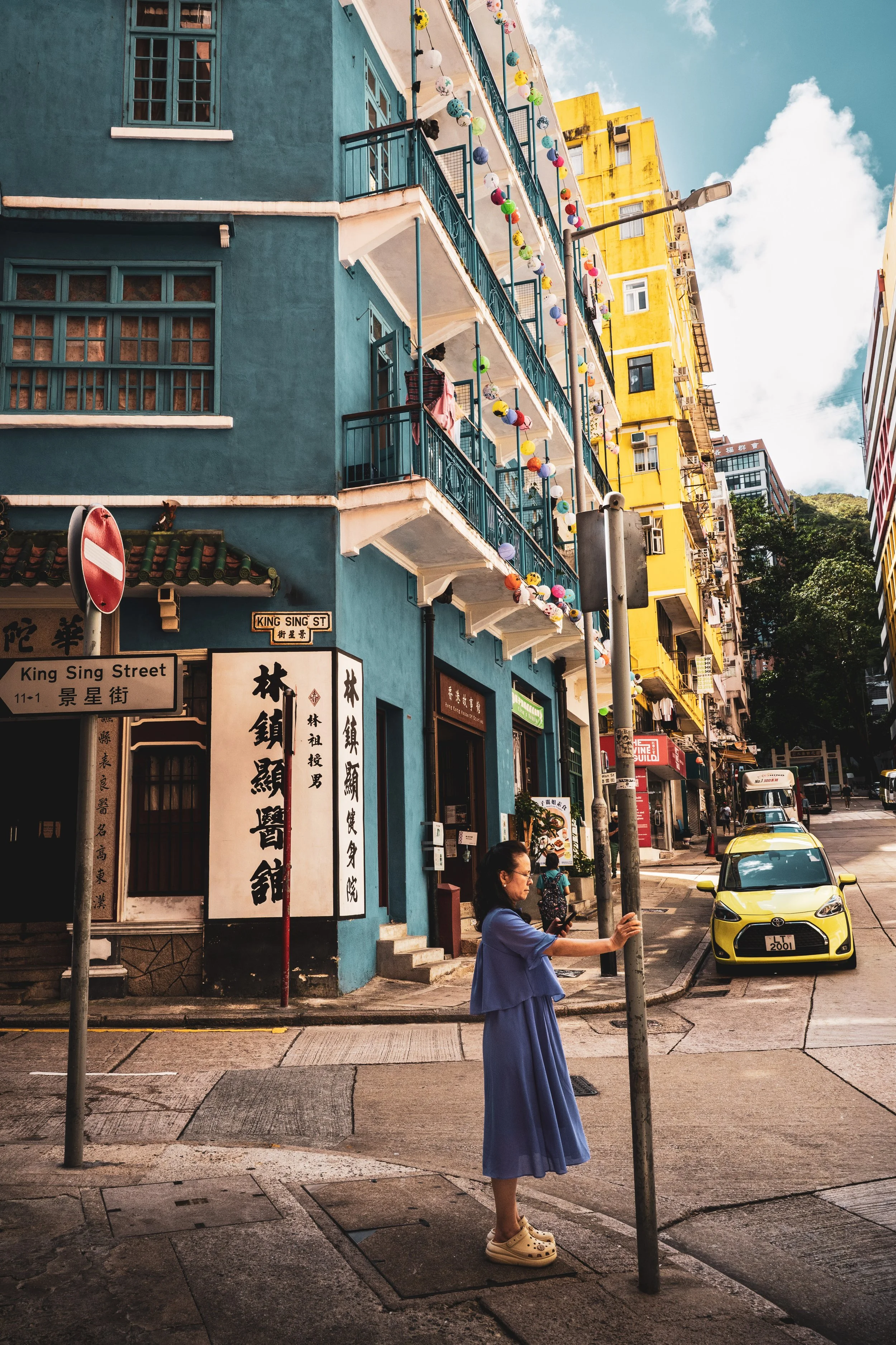 The Bright yellow Kam Sek building and the Blue House on Stone Nullah Lane.