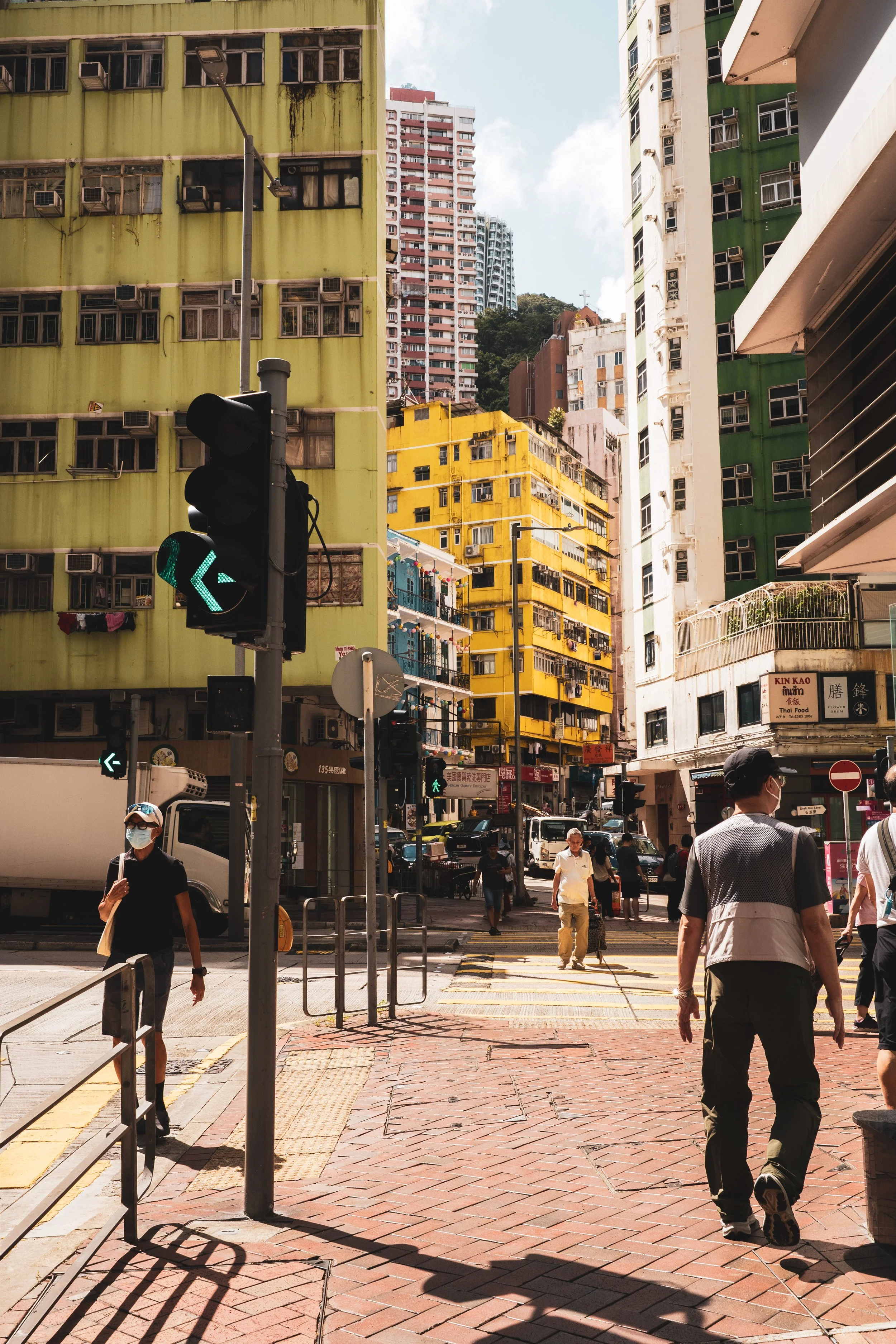 Looking towards the Bright yellow Kam Sek building and the Blue House on Stone Nullah Lane.