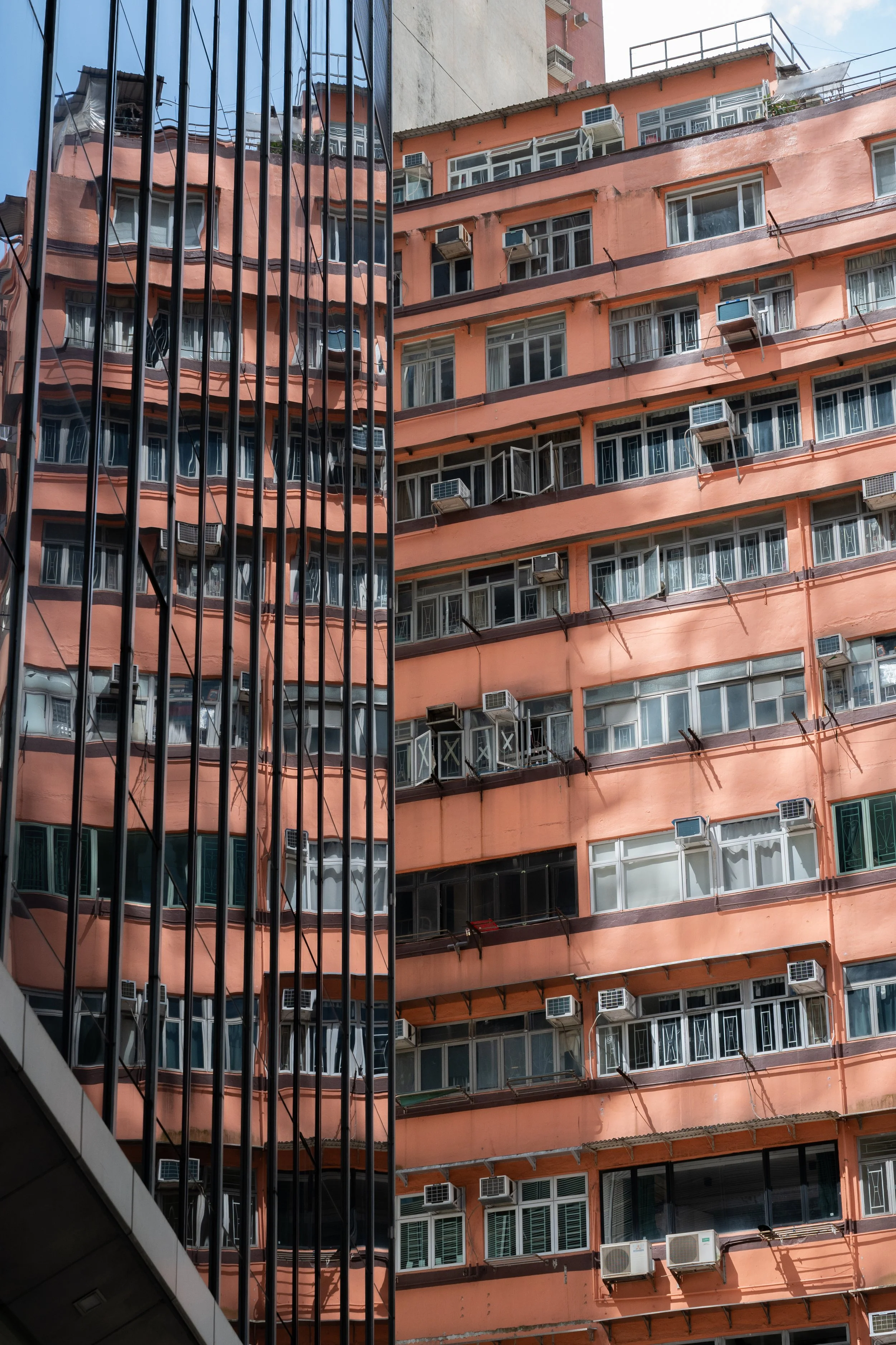 Shui Cheung Building reflected in Sunlight Tower windows