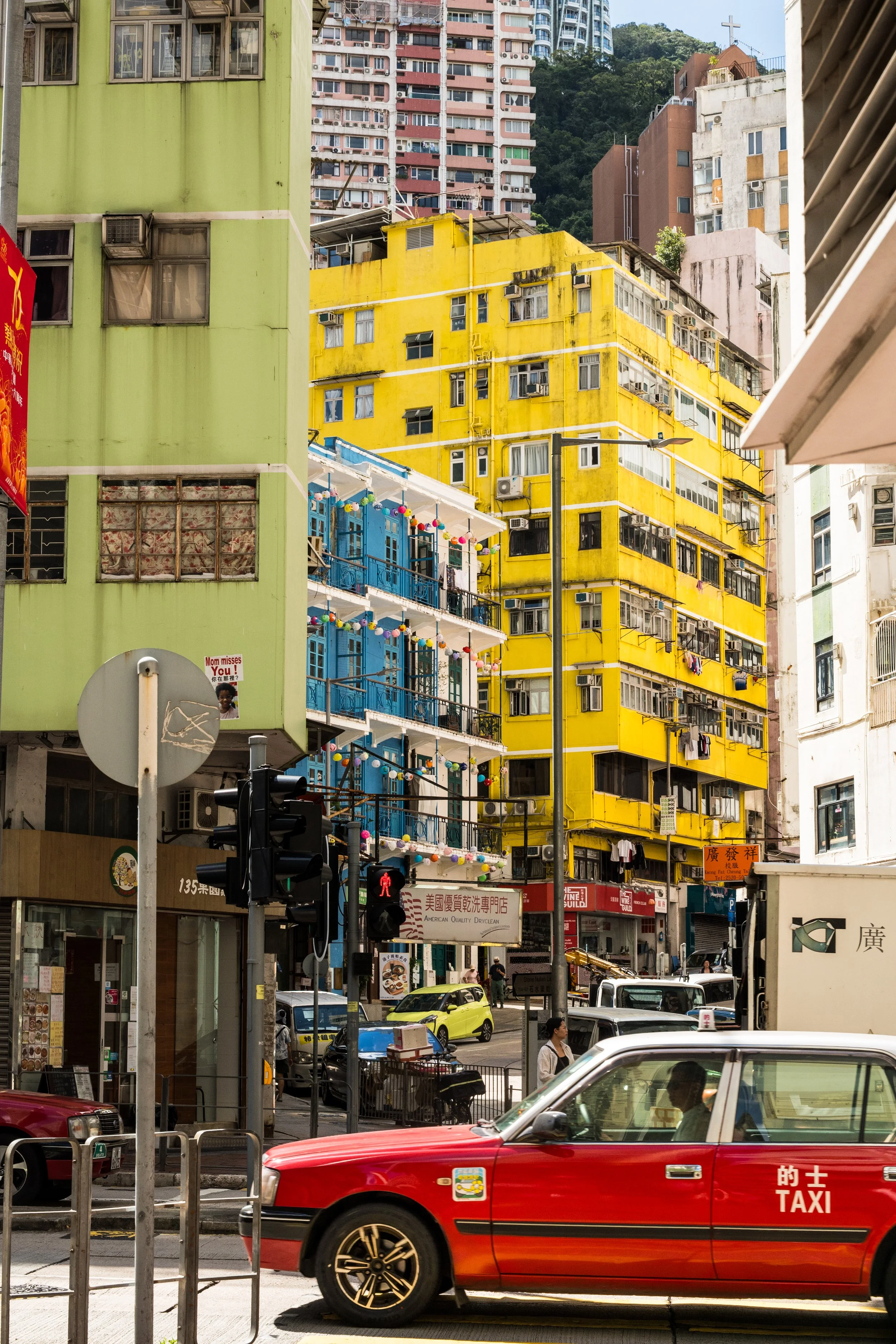 Looking towards the Bright yellow Kam Sek building and the Blue House on Stone Nullah Lane.
