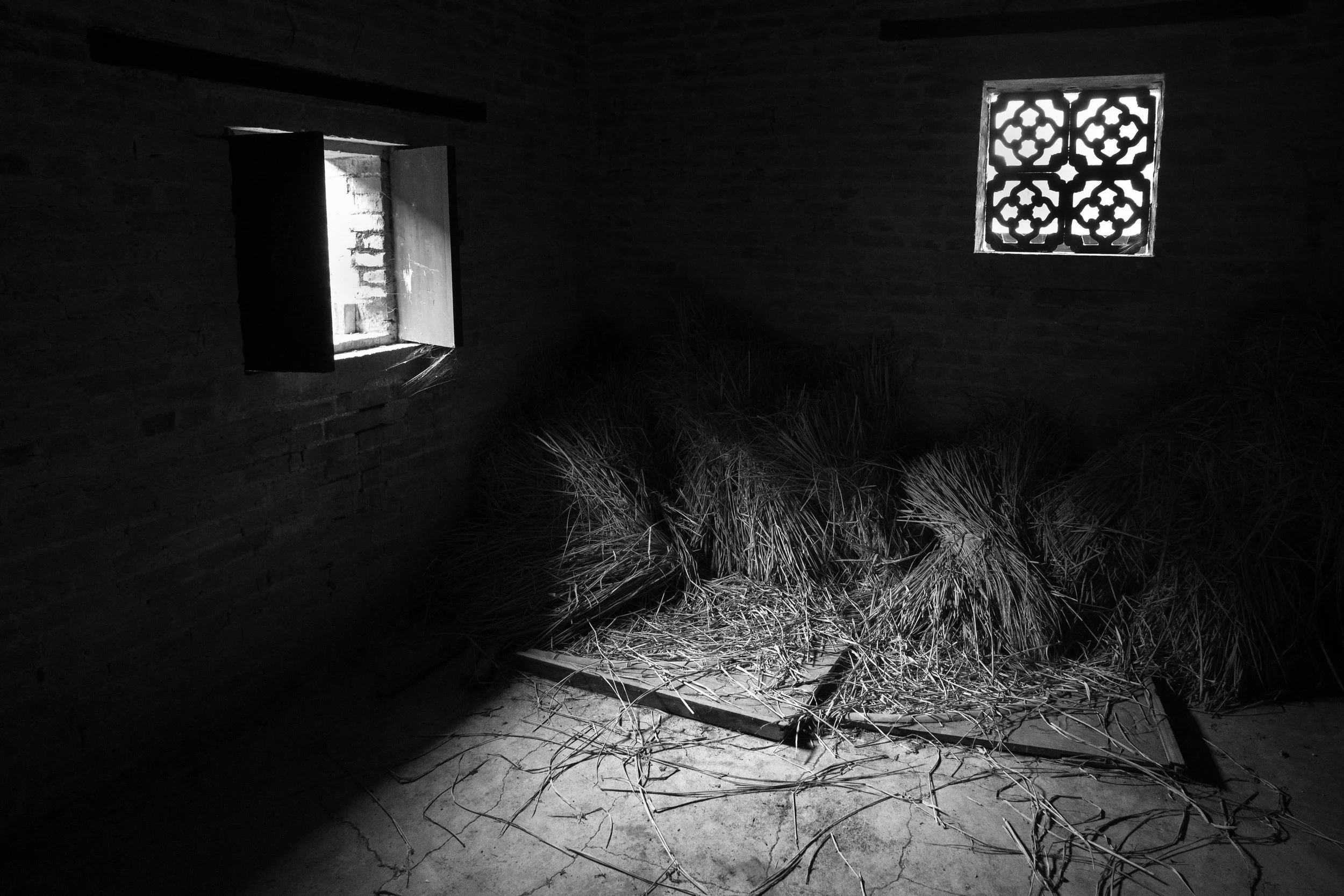Bales of something drying in a room in Langzi Ancient Village.