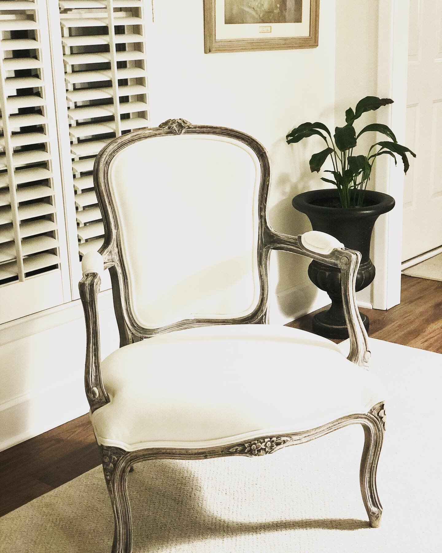 Have you ever tried bleaching your furniture? This vintage chair used to be a very dark mahogany stain with a rose colored fabric!
Then one day I got the idea to use fabric paint.  I painted the rose fabric in a creamy white. It became very stiff and
